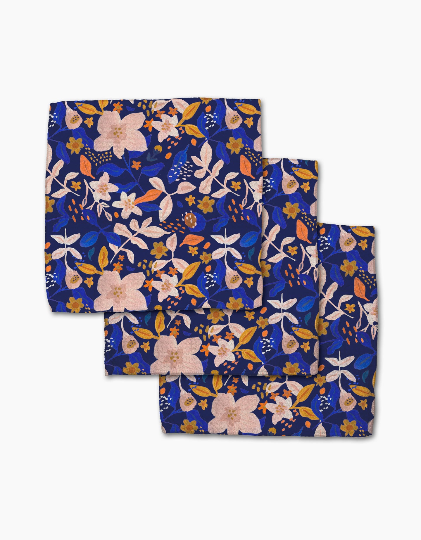 Three square Nightfall Garden napkins by Cottonflower Studio, featuring a blue background with pink, orange, white, and blue floral prints—crafted from recycled materials for an eco-friendly touch.