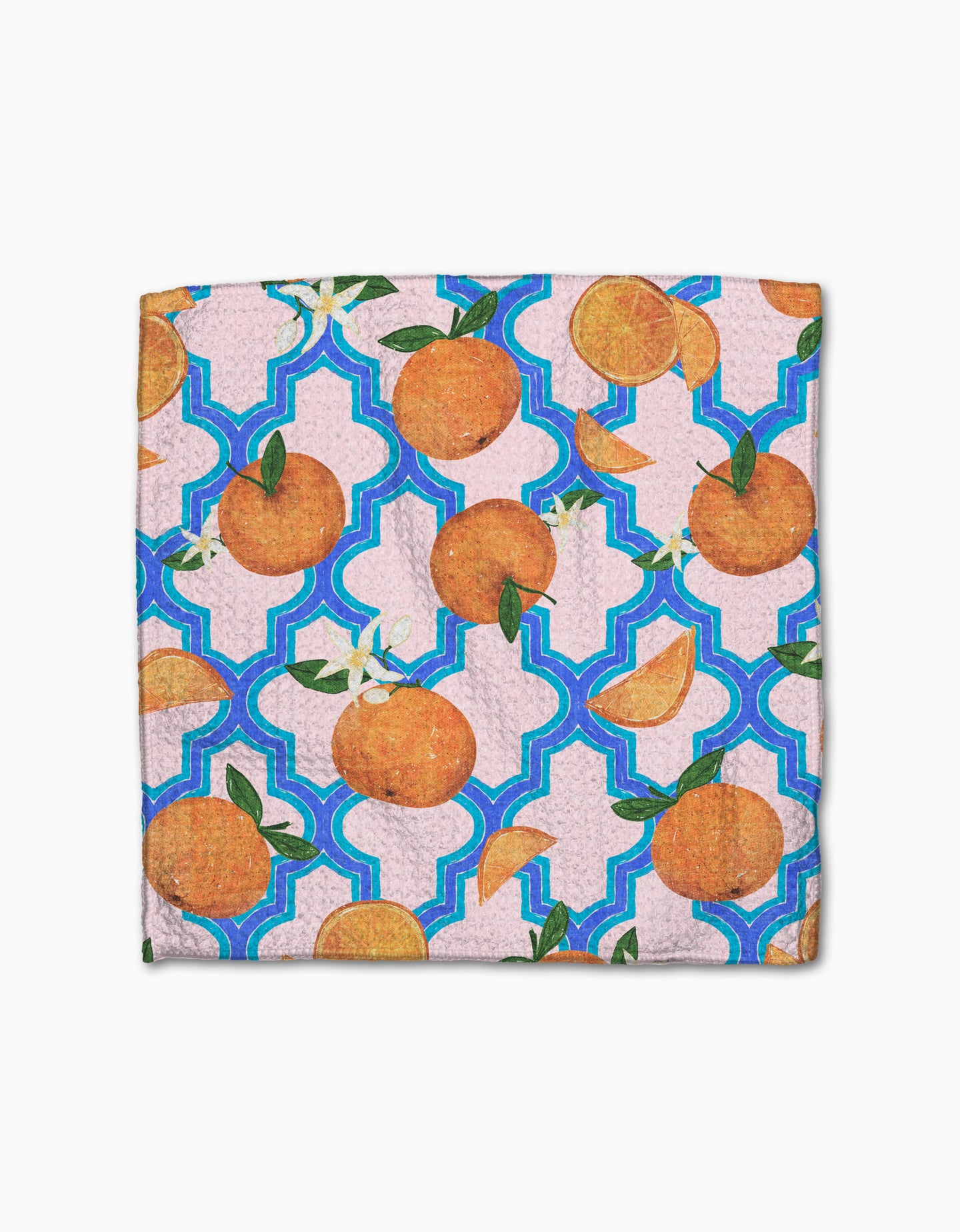 The Orange Trellis dishcloth set by Pascale Dilger features whole oranges and slices with green leaves on a purple background with blue geometric shapes. Made from recycled materials for an eco-friendly touch.