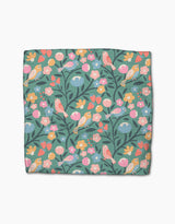 The Park Lane dishcloth by Charlie Rowan Designs features a colorful bird and floral pattern on teal Geoweave fabric, making it super-absorbent and ideal for daily use.