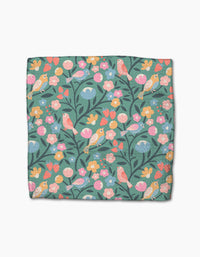 The Park Lane dishcloth by Charlie Rowan Designs features a colorful bird and floral pattern on teal Geoweave fabric, making it super-absorbent and ideal for daily use.