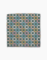 Park Lane by Charlie Rowan Designs features a geometric checkerboard quilt in teal, yellow, pink, white, and light blue on white. Made from ultra-absorbent Geoweave fabric, its symmetrical grid pattern spans the entire surface.