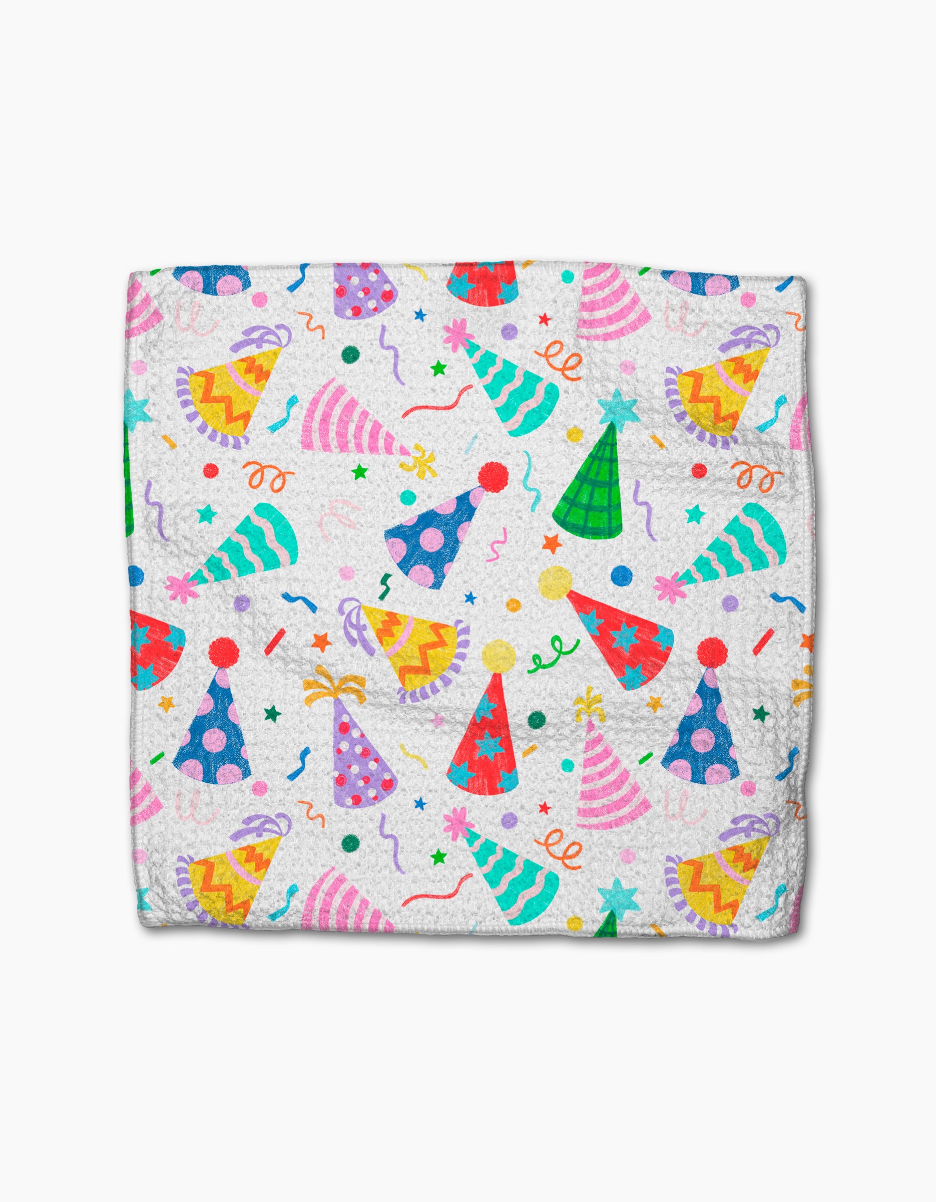 Party Pop by Vaishali Design Studio is a folded white blanket made from eco-friendly Geoweave fabric, featuring pink, blue, green, and yellow party hats with stars, confetti, and streamers scattered across the surface.