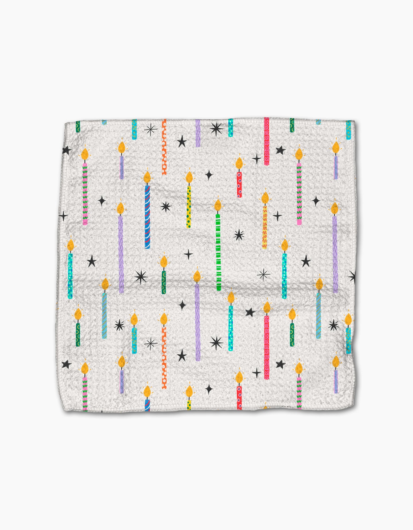 The Party Pop dishcloth by Vaishali Design Studio features a white textured Geoweave fabric with vibrant birthday candles, black stars, and yellow flames. Eco-friendly and durable, its perfect for adding a festive touch to your kitchen.