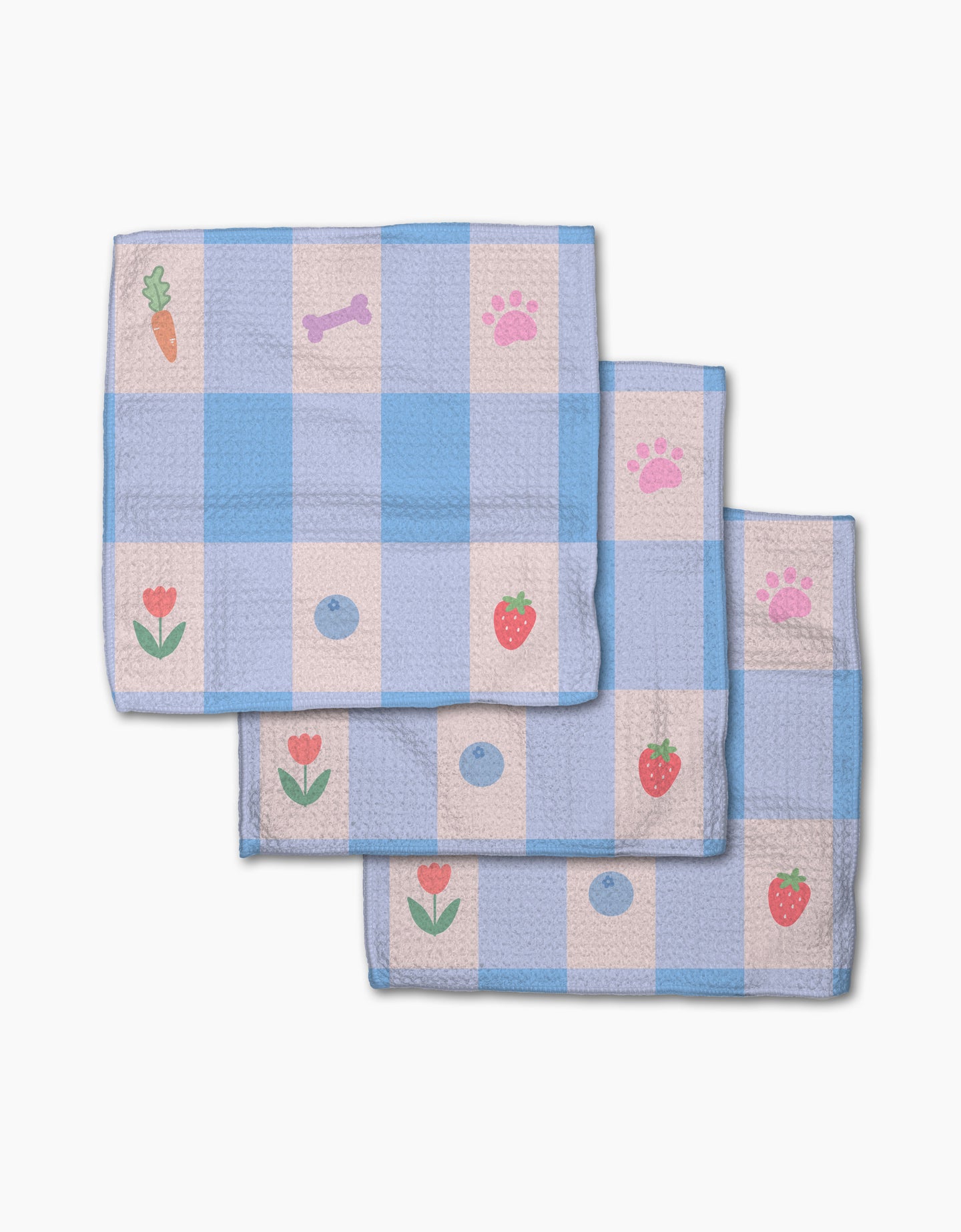 Pawfect Picnic by Letters By Shells: Three folded blue and white checkered dishcloths made from recycled materials feature cartoon prints—carrot, bone, paw print, flower, strawberry, and blue dot—stacked on a white background.