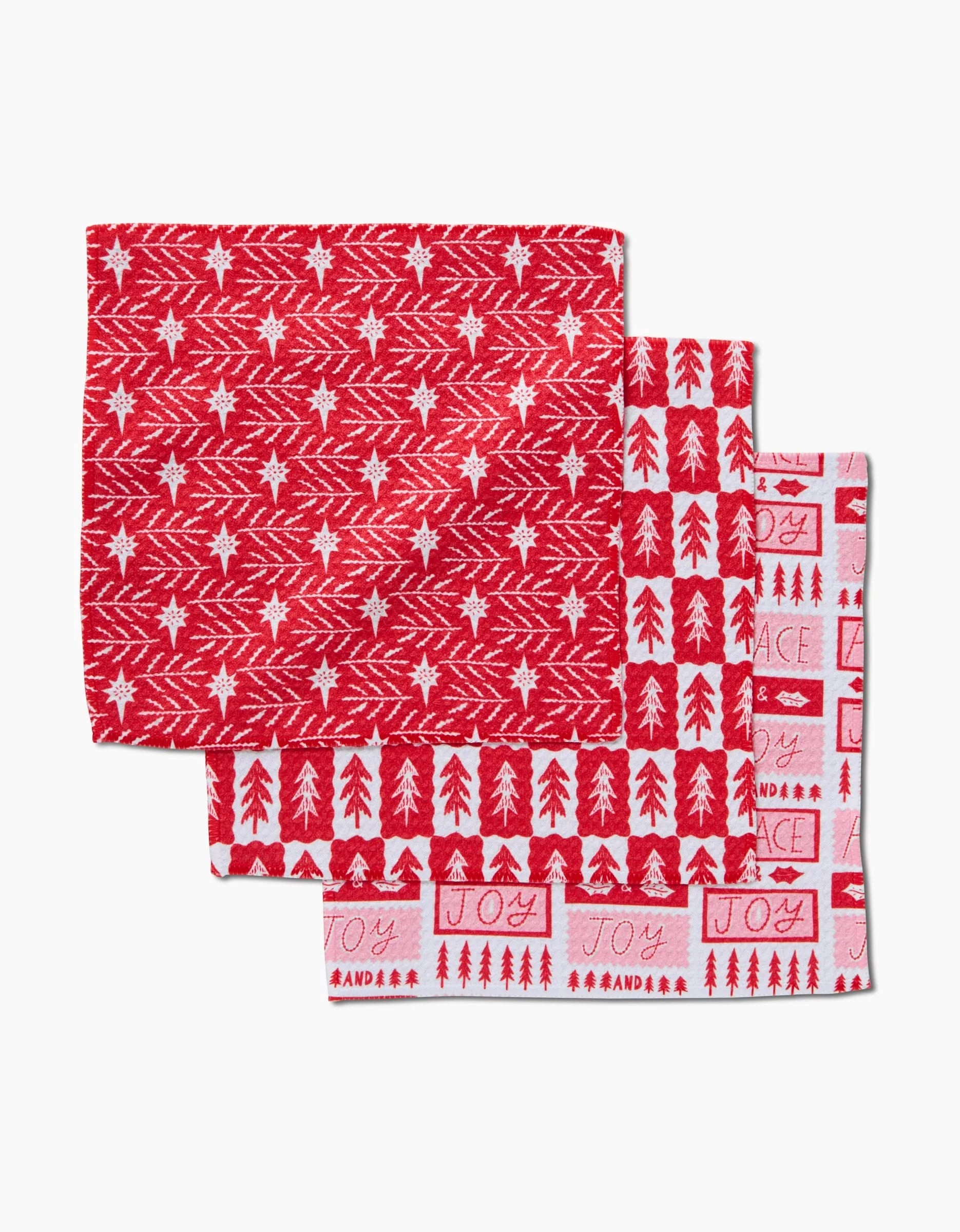 The Roxy Marj Peace And Love To All set features three holiday-themed Geoweave dish towels in red and white with tree, star, and festive word patterns for superior absorbency and durability.
