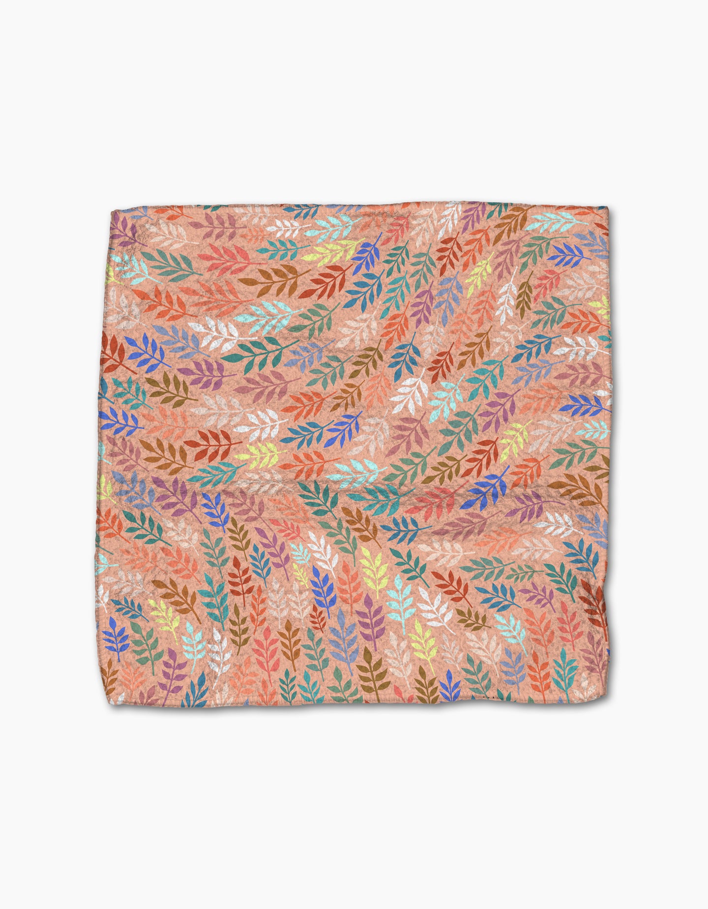 The Rachel Parker Peachy Leaf Swirl set features square dishcloths with a colorful leaf pattern—blue, orange, yellow, red, and green—on a peach background. Made from recycled materials with a soft, slightly wrinkled feel.