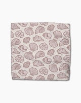 Pink Summer by Teri the Butter is a rectangular cloth made from recycled materials, featuring a repeating pattern of various pink seashell illustrations on a light beige background.