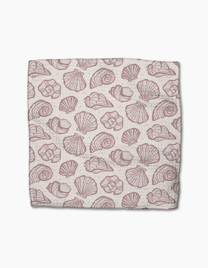 Pink Summer by Teri the Butter is a rectangular cloth made from recycled materials, featuring a repeating pattern of various pink seashell illustrations on a light beige background.
