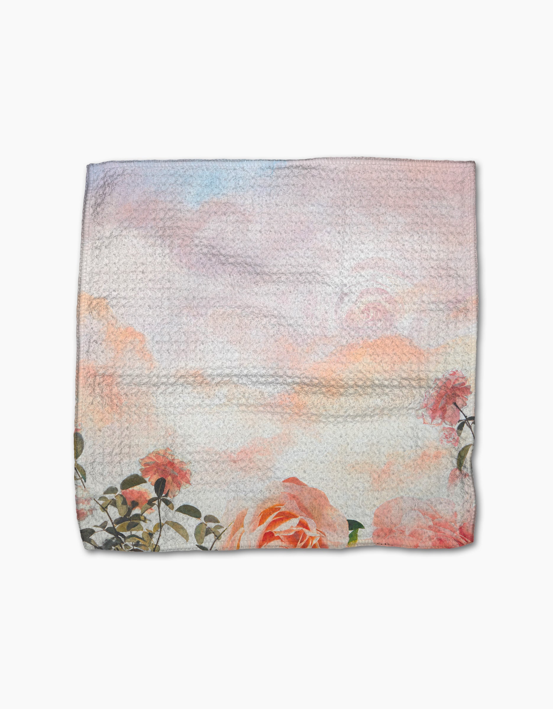 The "Rhapsody in Bloom" cloth napkin by Stefanie Bales features pink roses along the bottom edge and a pastel sky design on a white, textured background, crafted from recycled materials.