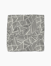 The Rhythm Current Stripes dishtowel by Sarah Daugherty features a folded, super-absorbent design with black and white geometric diagonal stripes, triangles, and dotted lines on a light background.