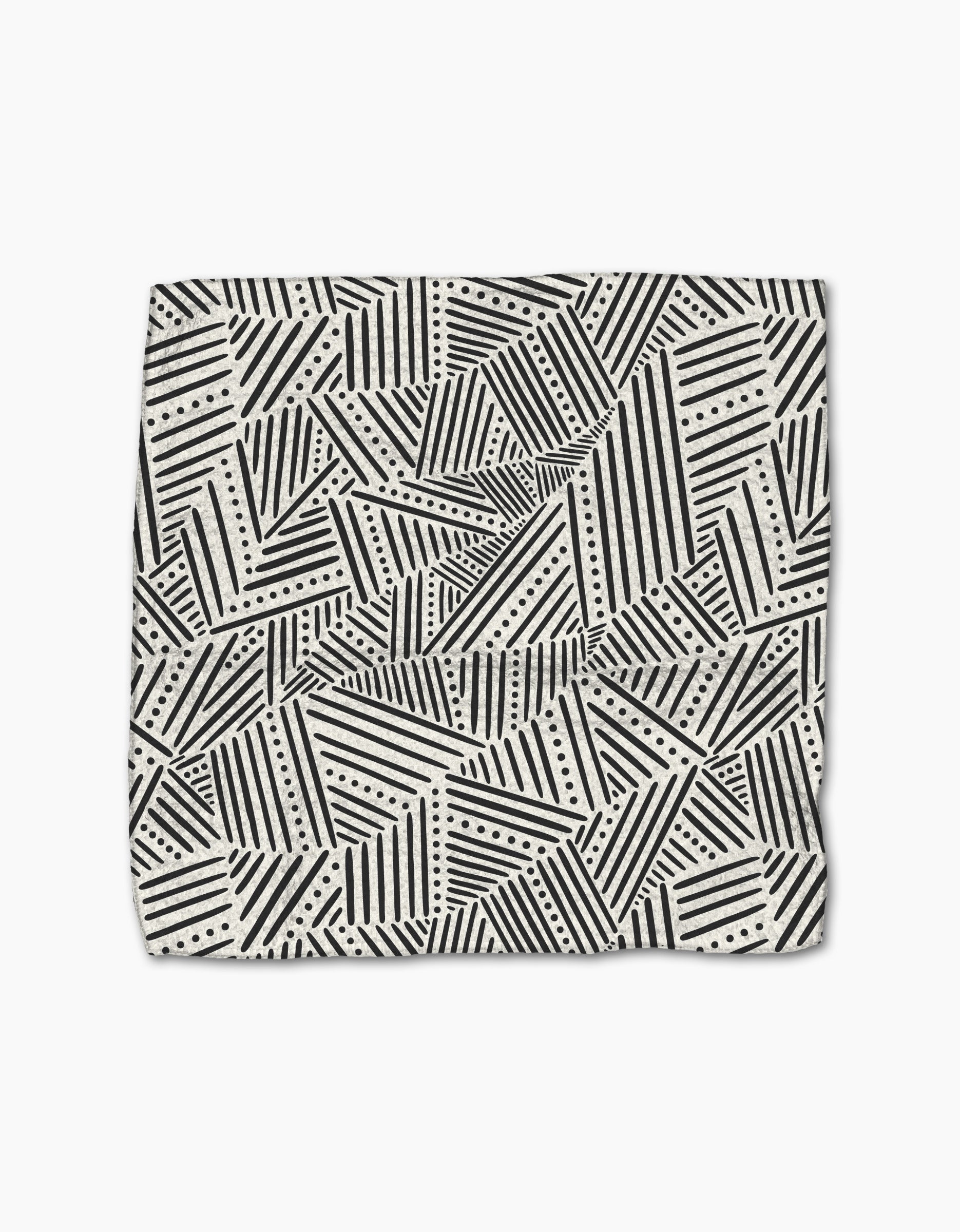 The Rhythm Current Stripes dishtowel by Sarah Daugherty features a folded, super-absorbent design with black and white geometric diagonal stripes, triangles, and dotted lines on a light background.