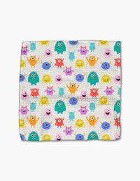 The Scribble Squad blanket by Vaishali Design Studio features a colorful pattern of cartoon monsters in unique shapes and colors on a white background, made from recycled materials for an eco-friendly, playful touch.