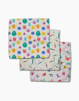 Scribble Squad by Vaishali Design Studio features three folded dishcloths in colorful cartoon monster, school supply, and letter/creature patterns—all made of soft, absorbent Geoweave fabric.