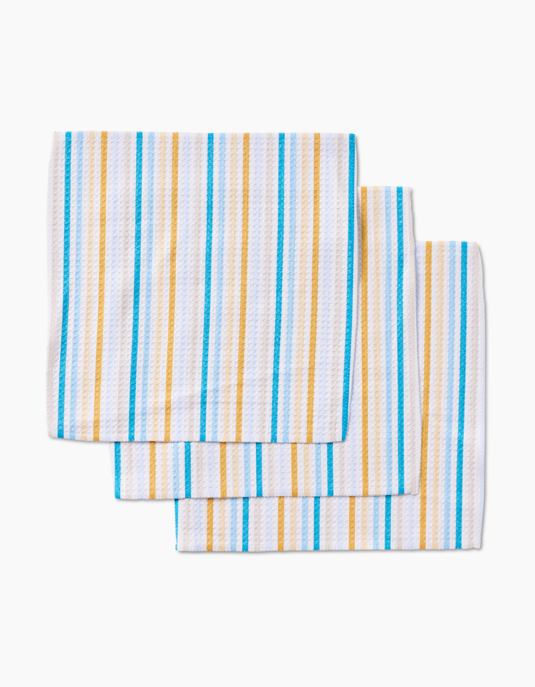 Three folded GEOMETRY Seaside Sunshine kitchen towels, made from recycled materials and featuring vertical yellow and blue stripes, are stacked in a neatly layered look on a white background.