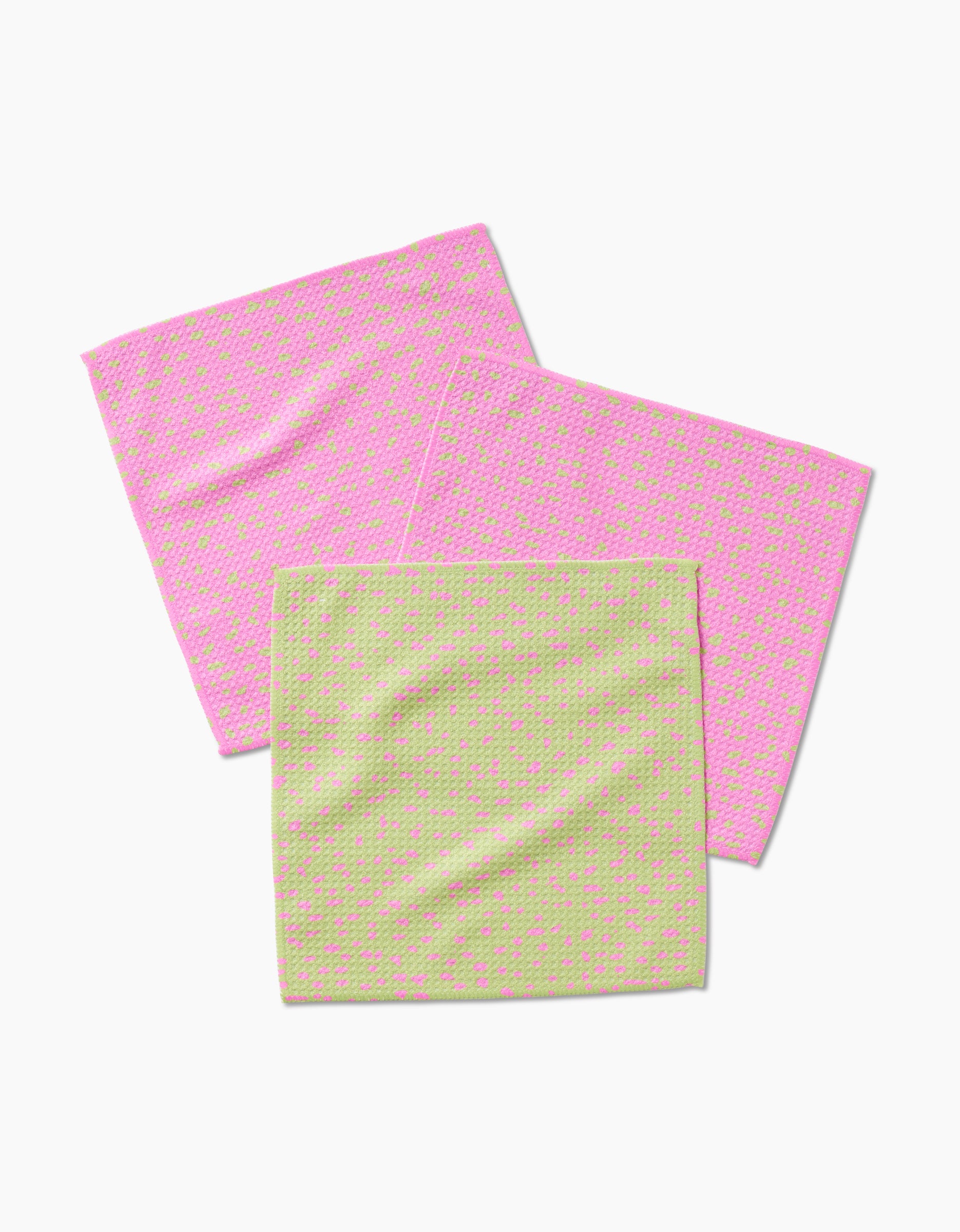 Three GEOMETRY Speckle Green Pink cleaning cloths—two pink with green dots, one light green with pink dots—made from Geoweave fabric are arranged on a white background.
