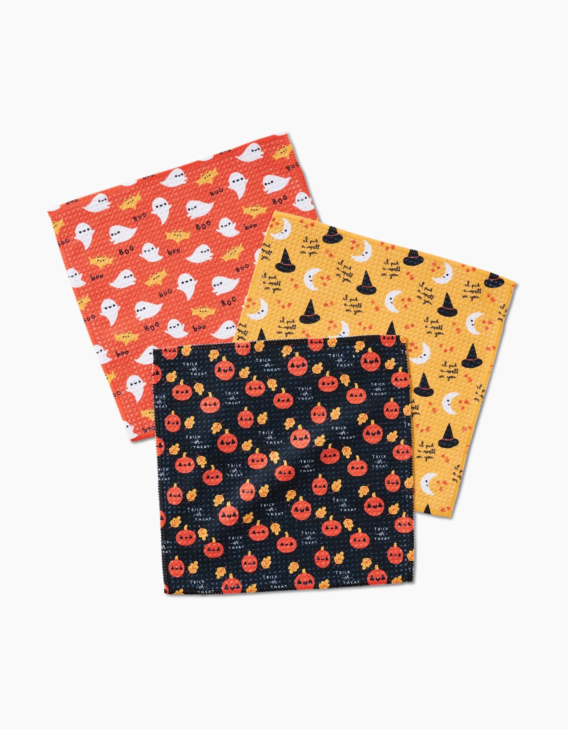 Spooky Season by Genna Blackburn includes three Geoweave dishcloths with Halloween designs: white ghosts on orange, witch hats and stars on yellow, and jack-o’-lanterns on black—displayed overlapping on white.