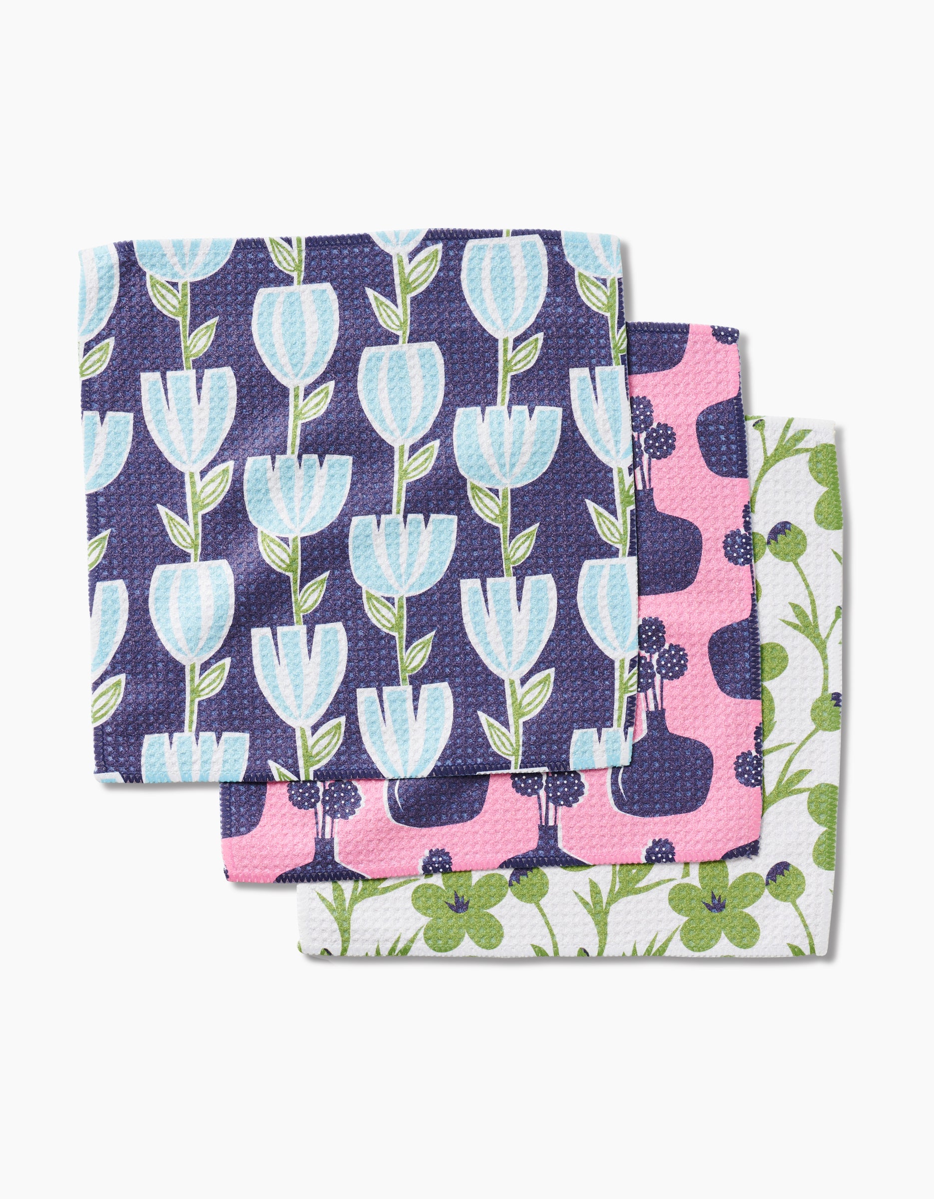 The Lizzie Clark Spring Bouquet set features three decorative dishcloths in blue tulips on navy, purple berries on pink, and green clovers with vines on white, all made from super-absorbent Geoweave fabric.
