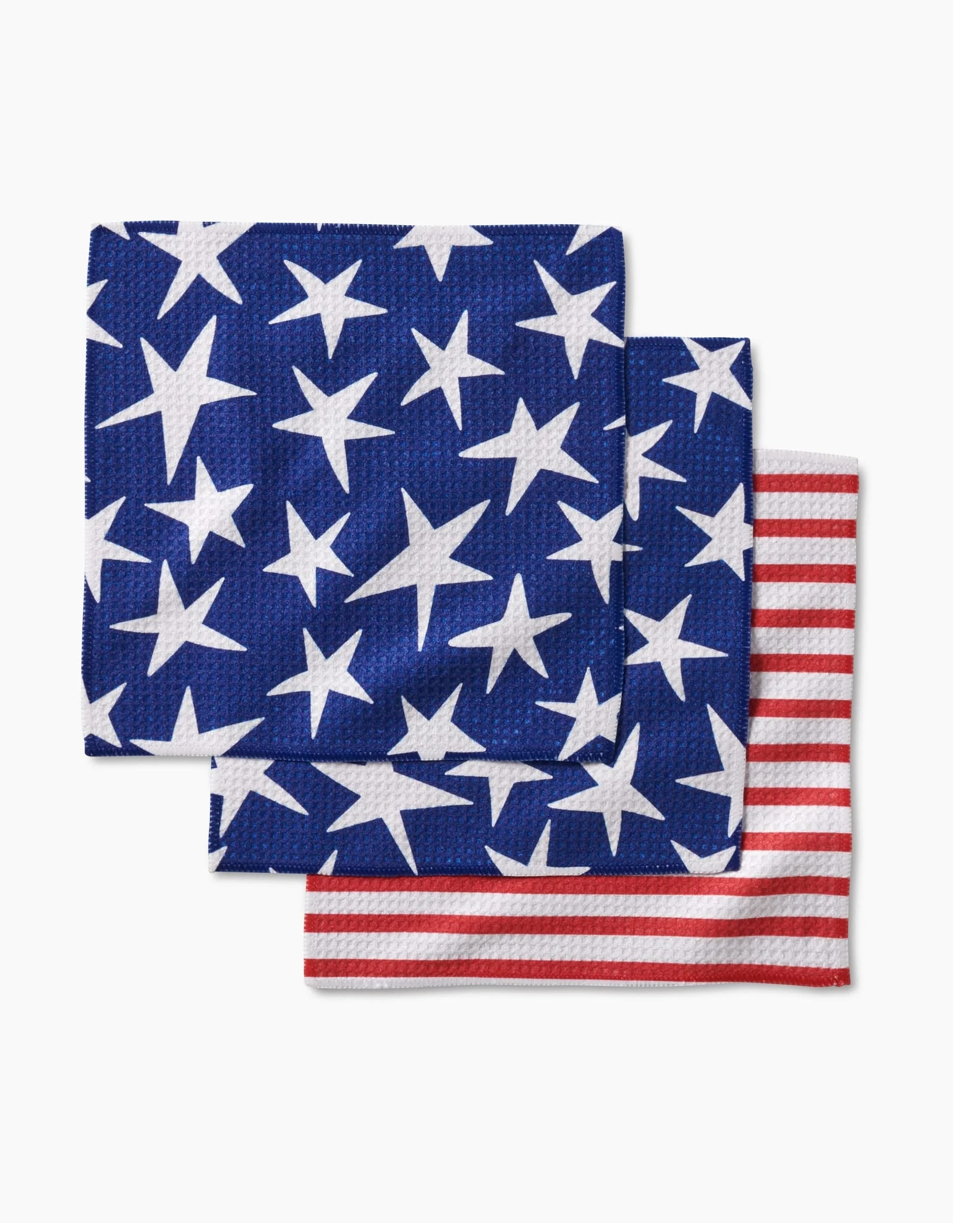 The Mindfulnice Stars And Stripes dishcloth set includes three super-absorbent, eco-friendly cloths made from recycled materials—two with white stars on blue and one with red and white stripes, reminiscent of the American flag.