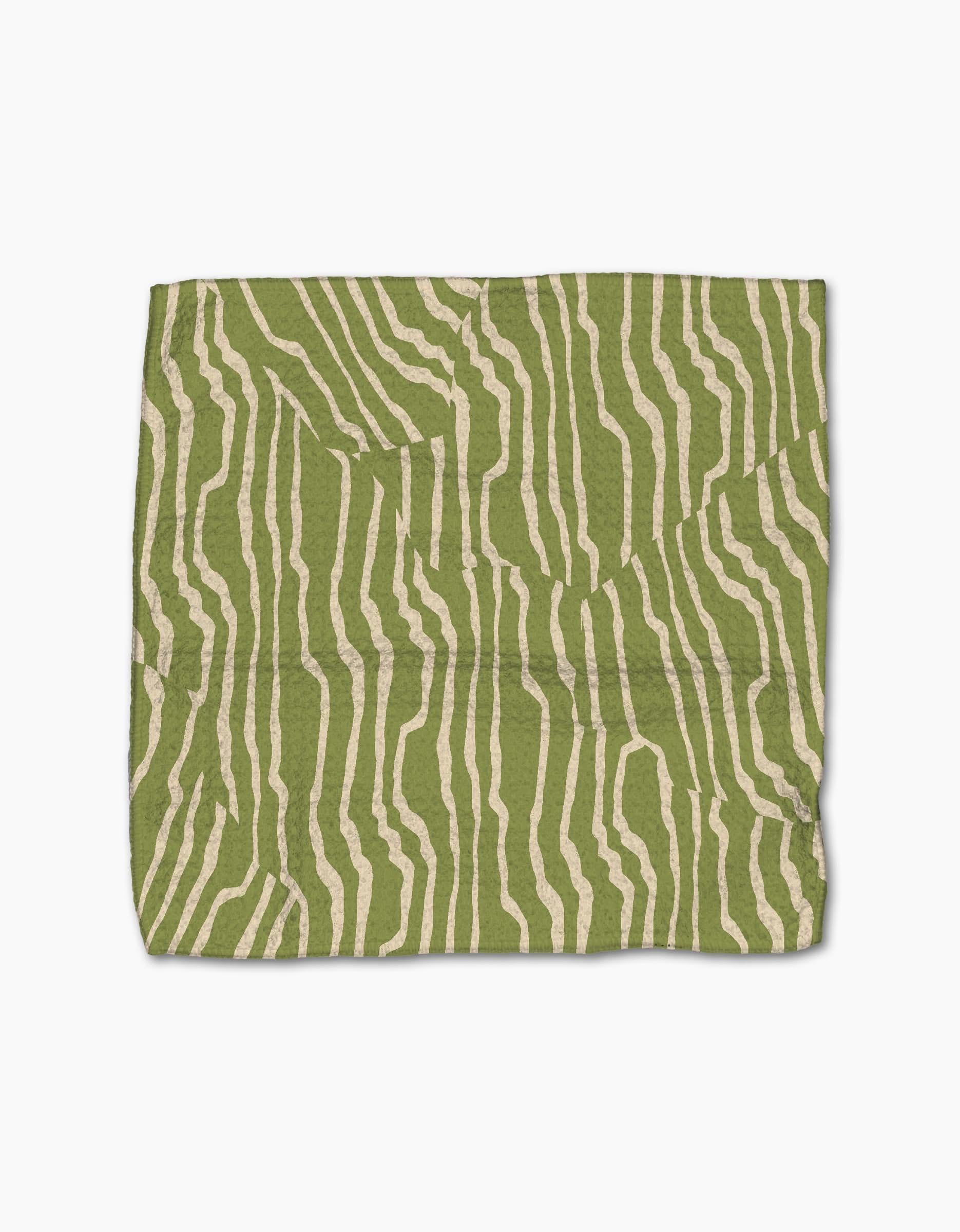 The Geometry Stripe Funk Grounds Green dishcloth features irregular beige wavy stripes on green, made from recycled materials and displayed flat on a white background.