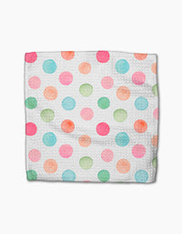 A Sweet Macarons cloth napkin by Elena Fay features a white Geoweave fabric adorned with watercolor polka dots in pink, blue, green, and orange, laid flat on a white background.