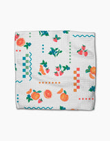 The Aubrey Fairchild Sweet Pickings dishcloth features a vibrant fruit and geometric pattern on white Geoweave fabric, blending style and super-absorbent performance.