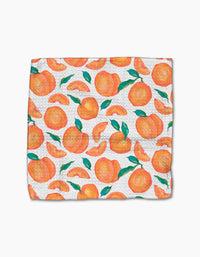 The Sweet Pickings dishcloth by Aubrey Fairchild features a vibrant pattern of whole peaches, peach slices, and green leaves on ultra-absorbent Geoweave fabric.