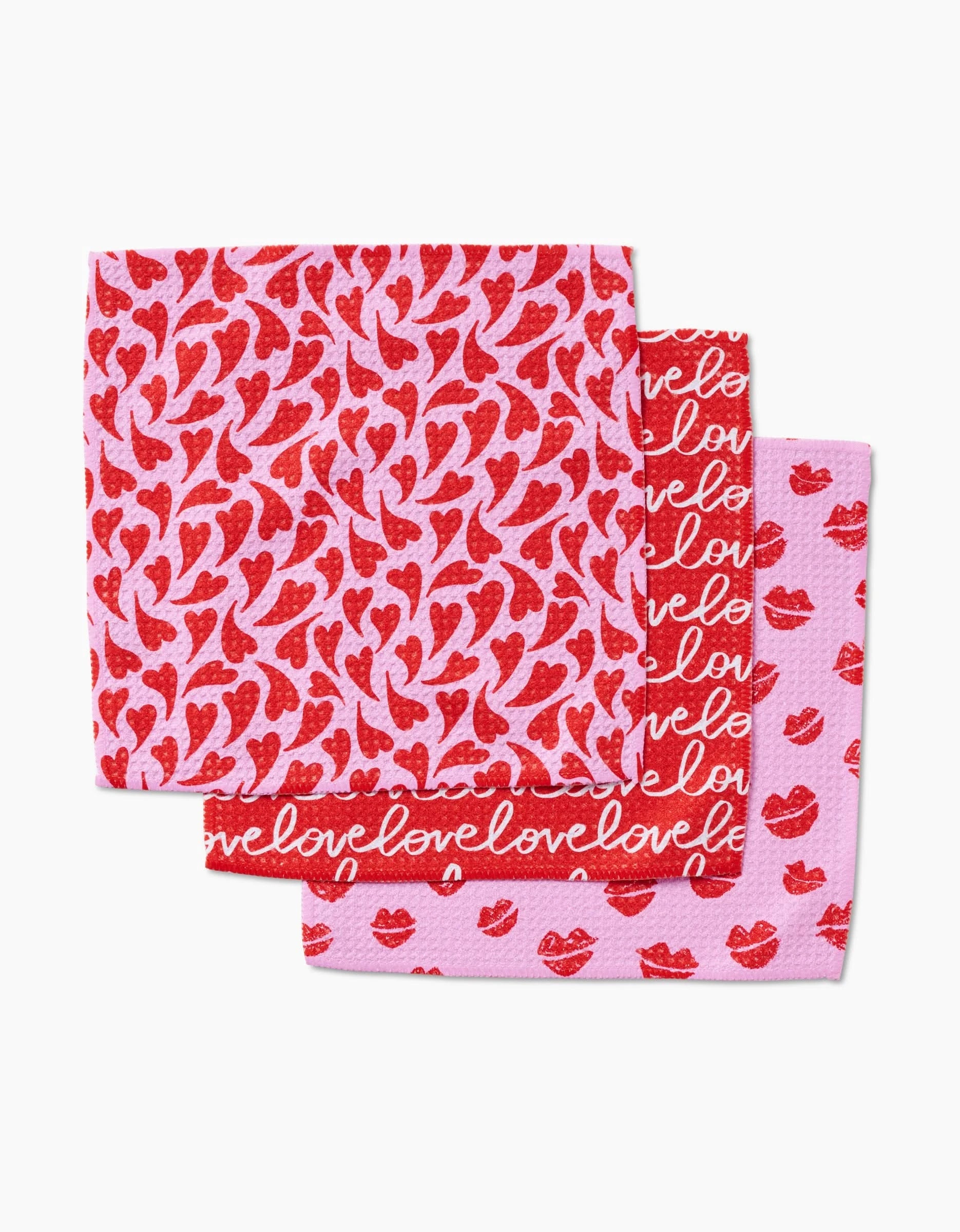 Kayla Ann’s Swooning Hearts includes three pink dishcloths made from recycled materials, featuring Valentine designs: hearts on one, “love” text on another, and lips on the third.