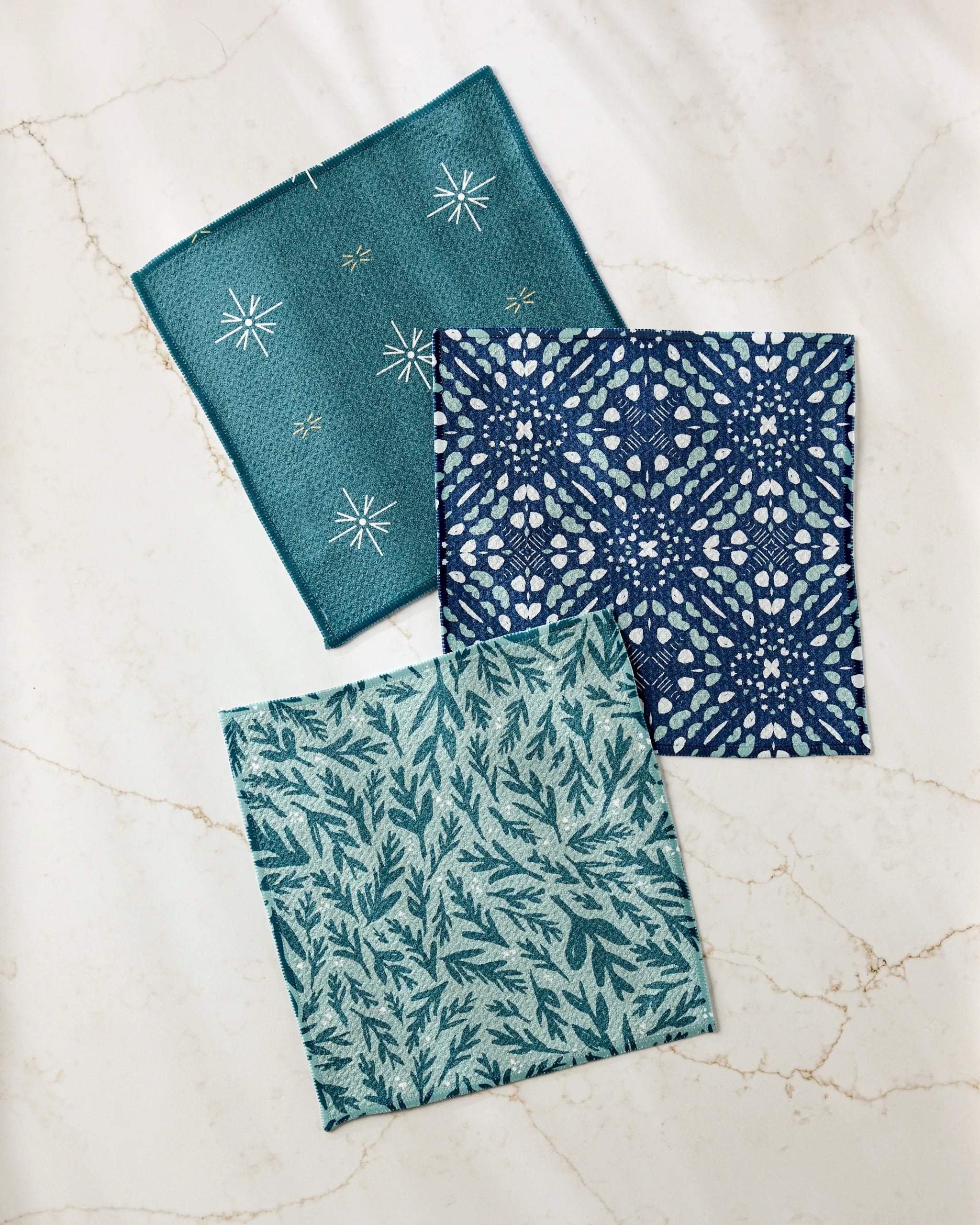 Twig + Spark’s Trail Dusting super-absorbent dishtowels, made from recycled materials, displayed on a marble surface.
