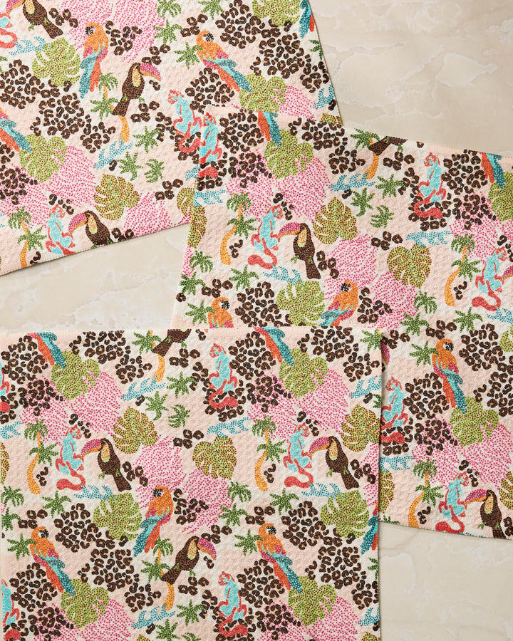 Three Geometry Tropi Hotel rectangular placemats showcase a vibrant nature-inspired pattern with birds, leaves, and flowers in pink, green, orange, and brown on a light background—perfect paired with your favorite absorbent kitchen towels.