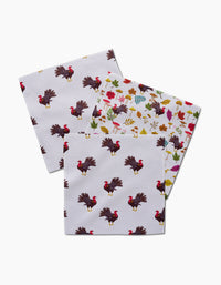 Vaishali Design Studio’s Turkey Day Parade includes three recycled paper napkins: two with a repeating turkey pattern and one with colorful autumn leaves, acorns, and berries, all displayed on a white background.