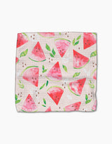 The Elena Fay Watermelon Slice dishcloth features Geoweave fabric and a watercolor-style design with watermelon slices, green leaves, and scattered seeds on a light background.
