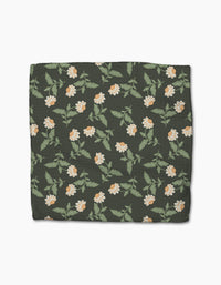 The Danelys Sidron Wildflower Vine Onyx is a dark green rectangular blanket made from recycled materials, featuring a repeating white and yellow floral pattern with green leaves, shown on a white background.