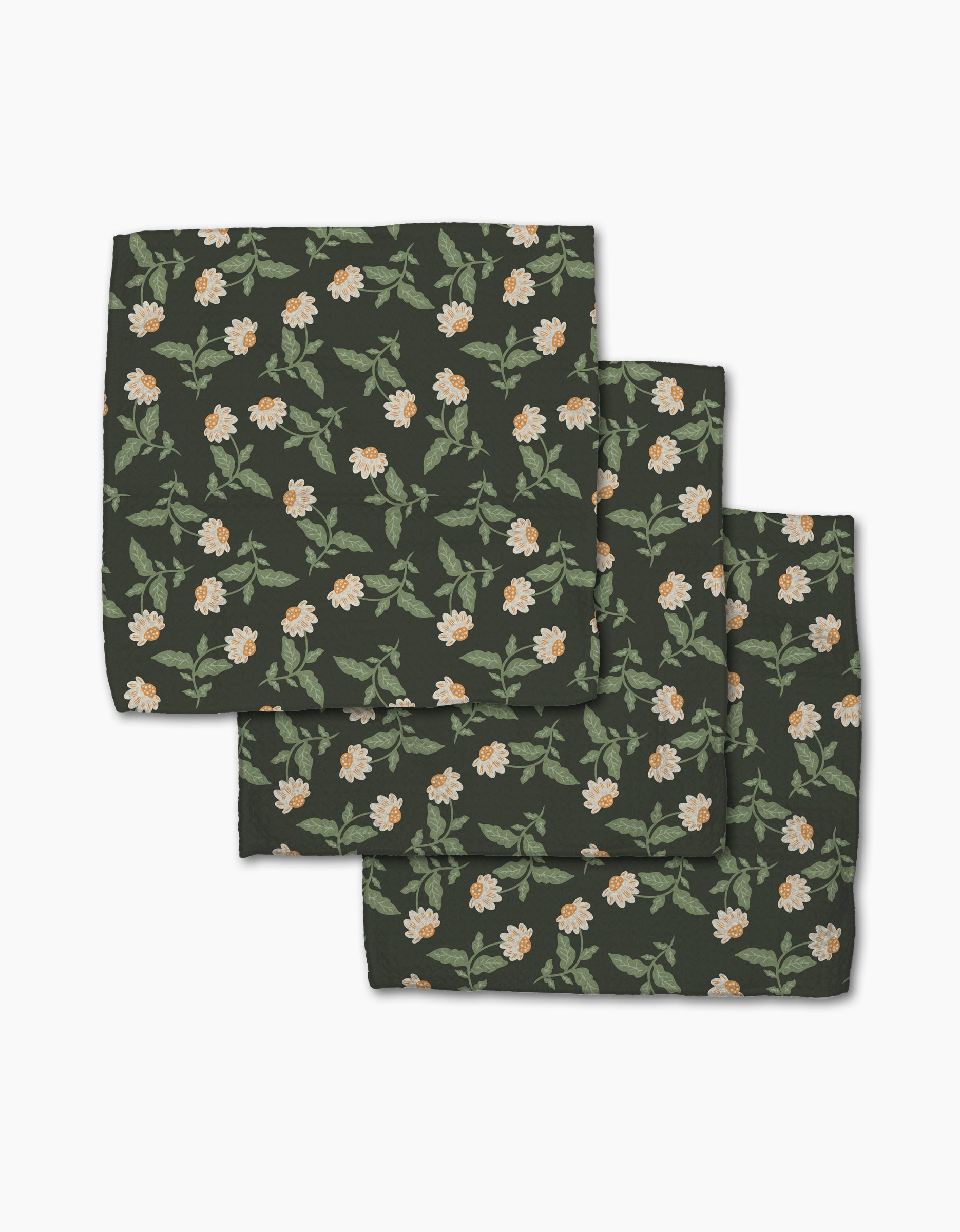 The Danelys Sidron Wildflower Vine Onyx set includes three dark green cloth napkins made from recycled materials, featuring a floral pattern with white and orange flowers and green leaves. The super-absorbent napkins come neatly folded.