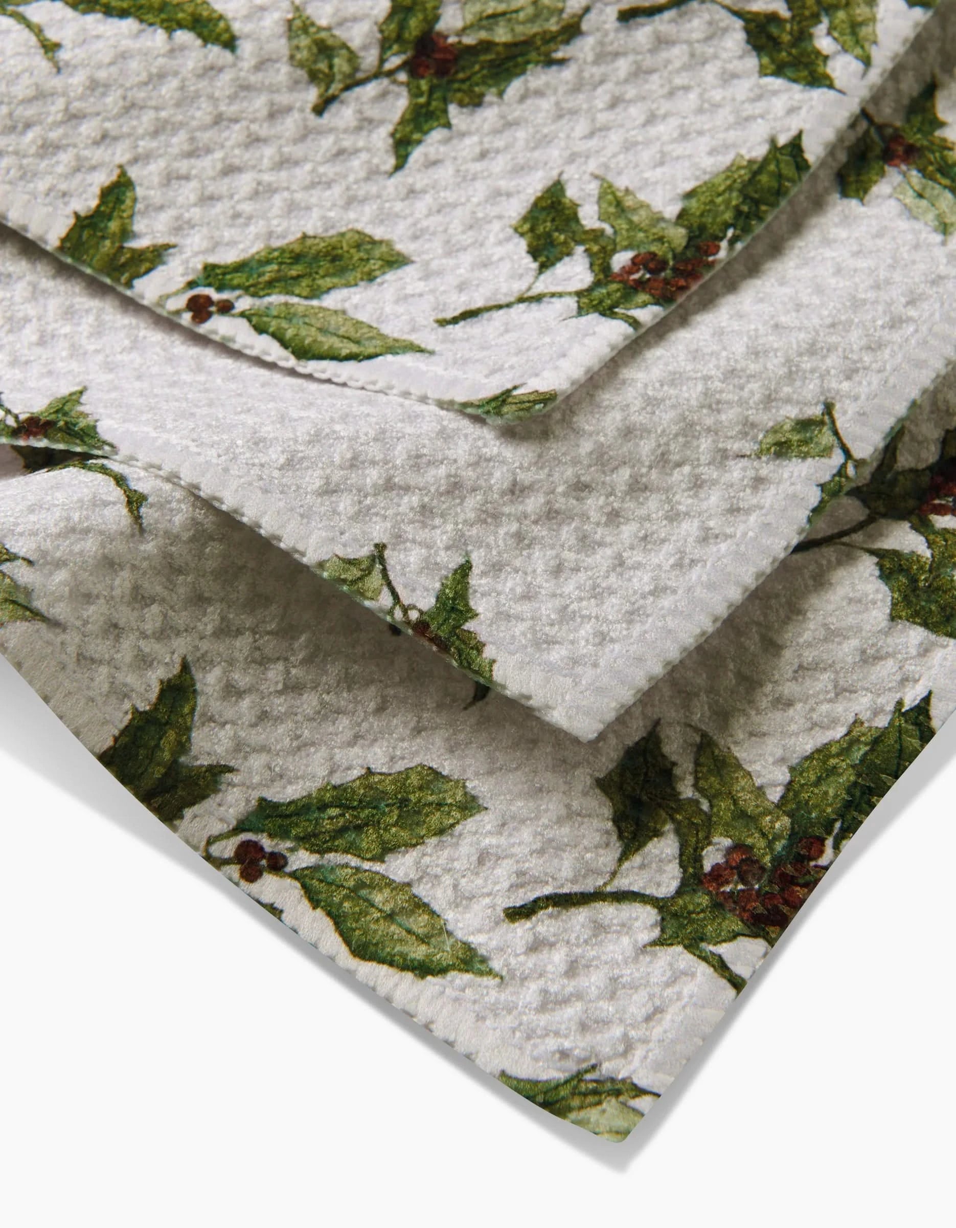 The Aubrey Fairchild Winter Berry napkins feature a festive green holly and red berry design on white Geoweave fabric, combining durability and style—perfect for your holiday or Christmas table. Includes three folded cloth napkins.