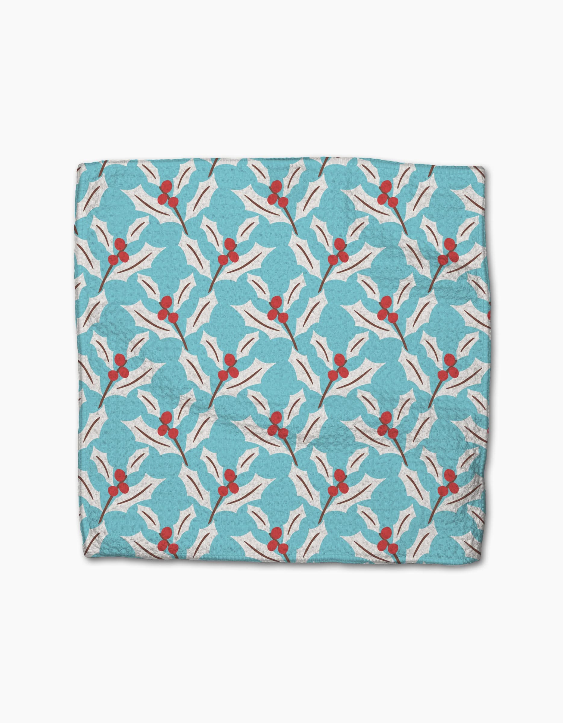 The Lizzie Clark Winter Holly blue blanket, made from recycled materials, features white holly leaves and red berries in a repeating pattern, shown spread flat on a white background.