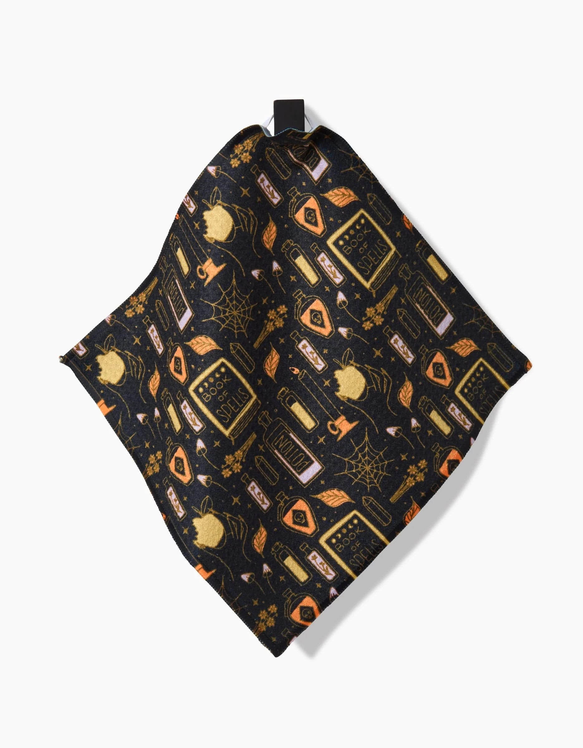 The Mandy Arroyo Witchy Things napkin is a dark recycled fabric with a Halloween pattern of gold and orange potion bottles, spiders, webs, skulls, candles, and stars.