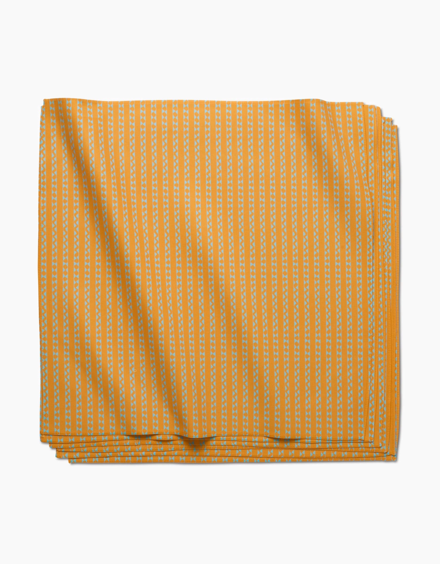 The Castillo Dinner Napkin by GEOMETRY features neatly folded yellow Geosuede fabric with vertical white dashed stripes, displayed stylishly on a white background.