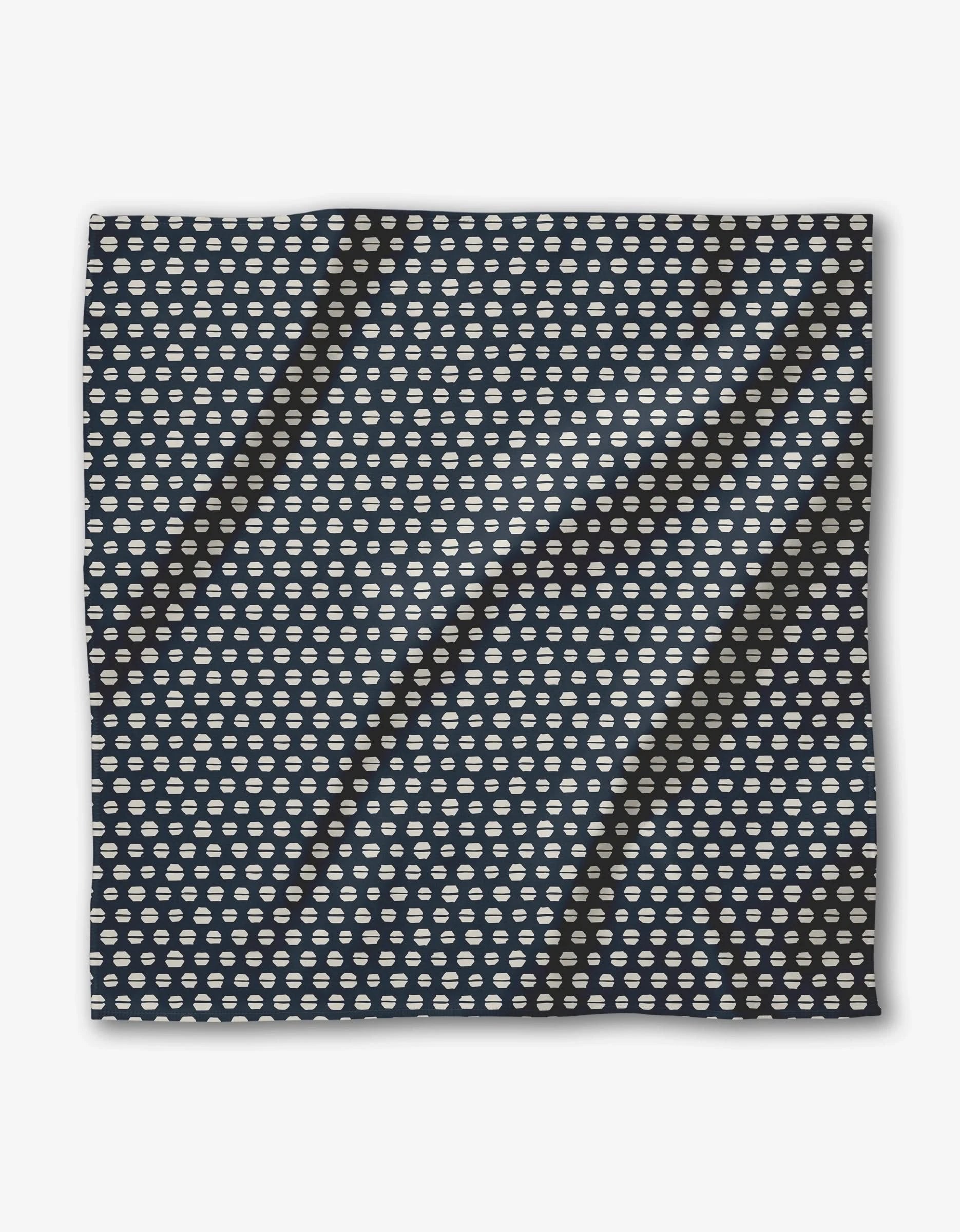 The Kealia square scarf by GEOMETRY features soft Geosuede fabric and a repeating pattern of small white cloud icons on a dark blue background, shown laid flat with slight wrinkles.