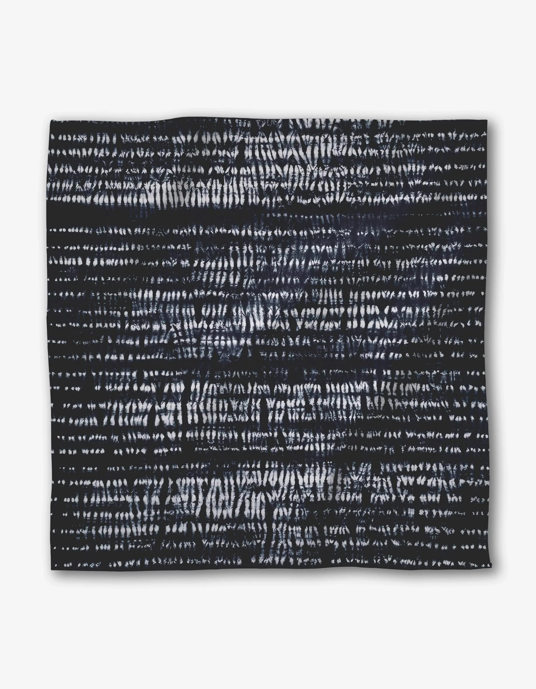 Shibo by GEOMETRY features a square black Geosuede fabric accented with irregular horizontal white lines and dashes, creating an abstract, textured pattern on its surface.