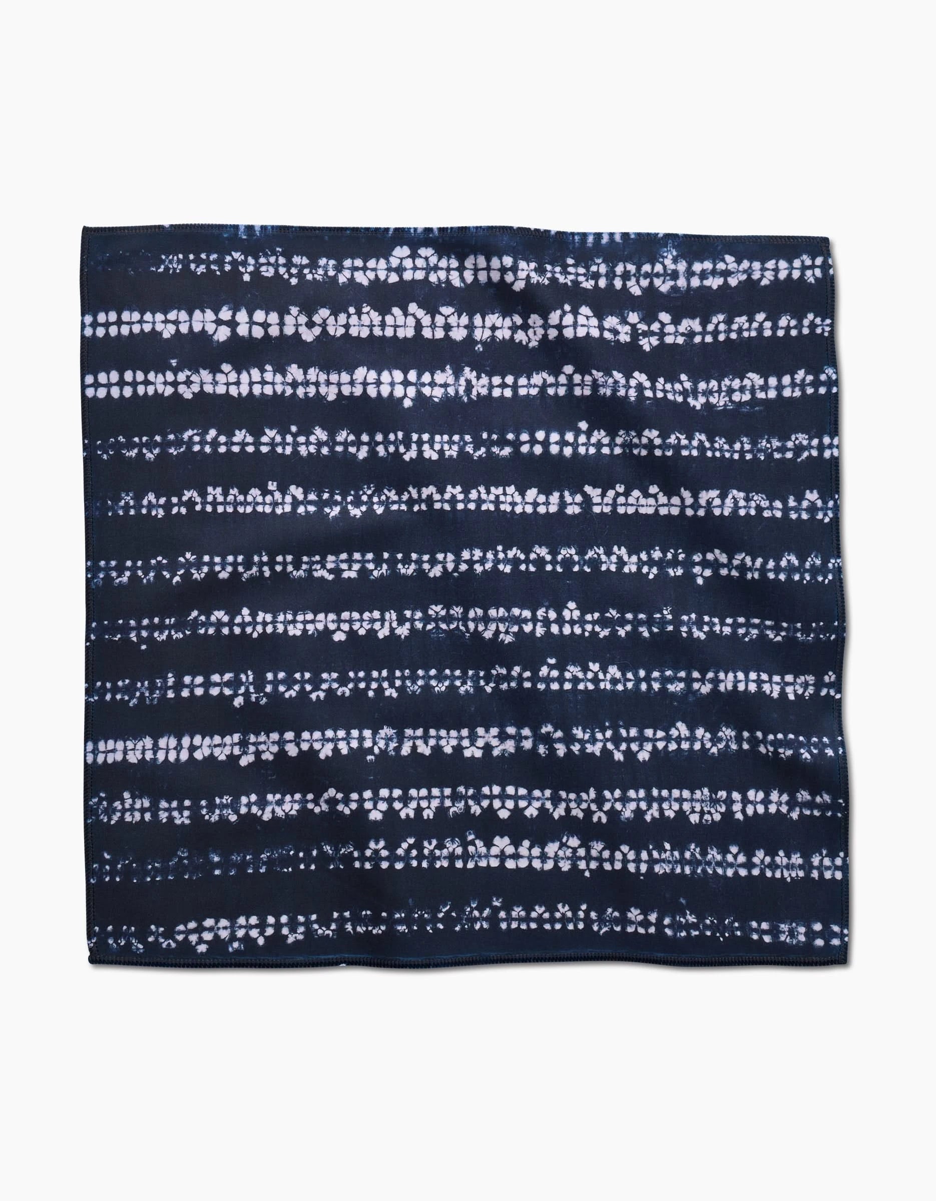 The Shibo by GEOMETRY features a rectangular dark navy blue Geosuede fabric with horizontal white dotted and dashed patterns, evoking a tie-dye or shibori design, shown on a plain white background.