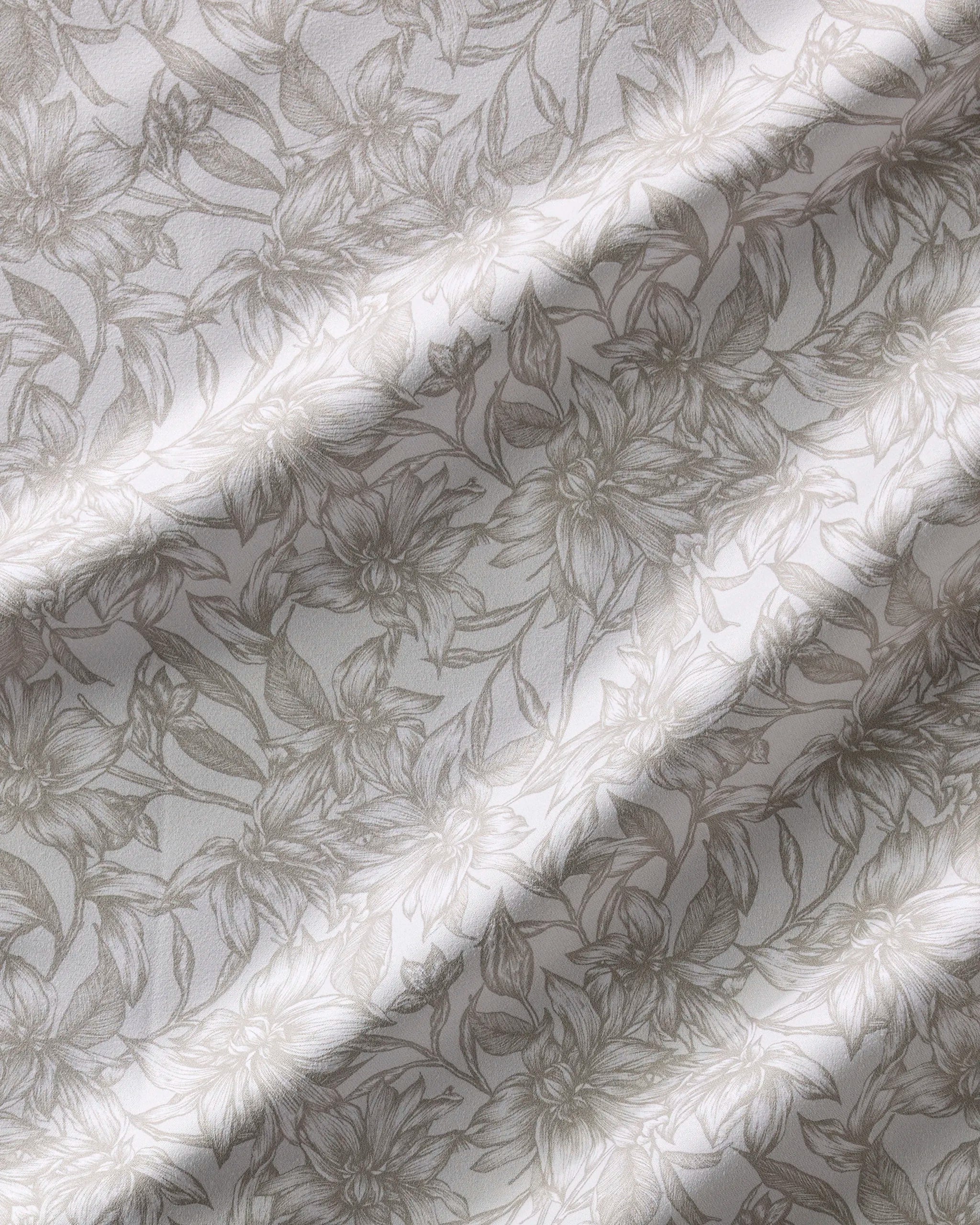 The Alba napkin set by Geometry features beige and white fabric with a floral line-art pattern. Soft, natural folds and a subtle sheen create gentle shadows, enhancing the intricate flower design. Absorbent and stylish for any table setting.