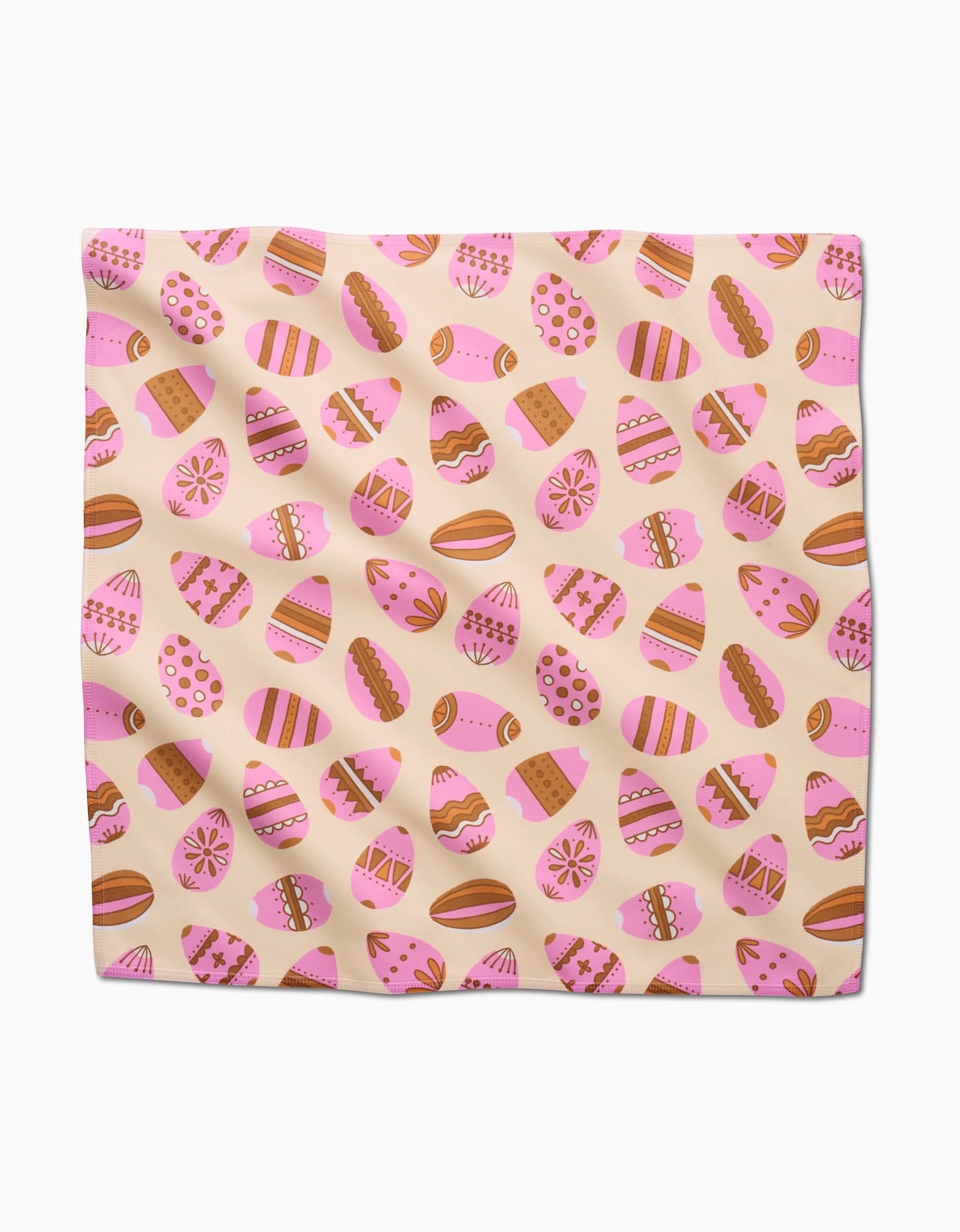 The Arledge napkin by Amy MacCready is a square, eco-friendly dinner napkin featuring decorated Easter eggs in pink, orange, and brown with stripes, dots, and floral patterns on a pale background.