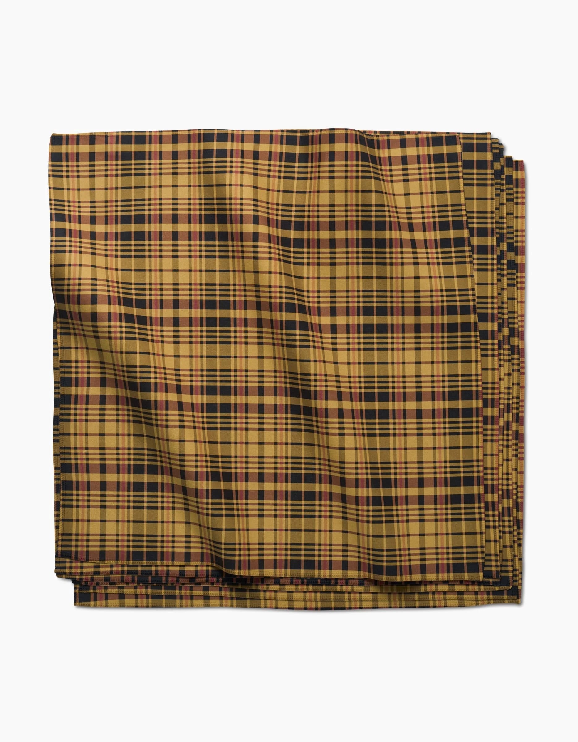 A folded Danelys Sidron Autumn Plaid napkin in yellow, black, and red is shown on a white background. Smooth and absorbent with gentle creases, it’s perfect for any dinner napkin set.
