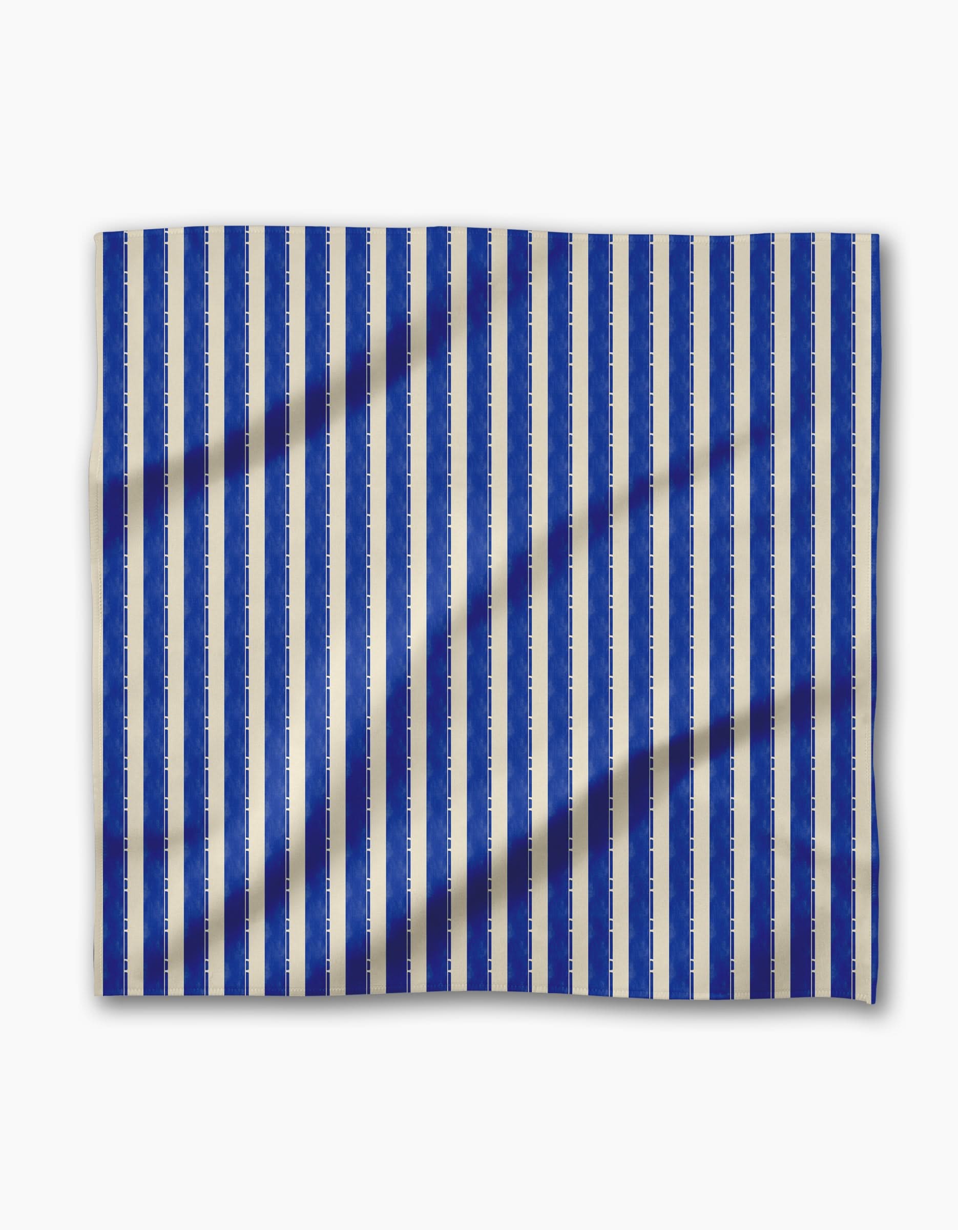 Geometry’s Bauhaus Stripe features vertical blue and white stripes on geosuede fabric with a subtle textured pattern—a chic choice for stylish dinner napkins.