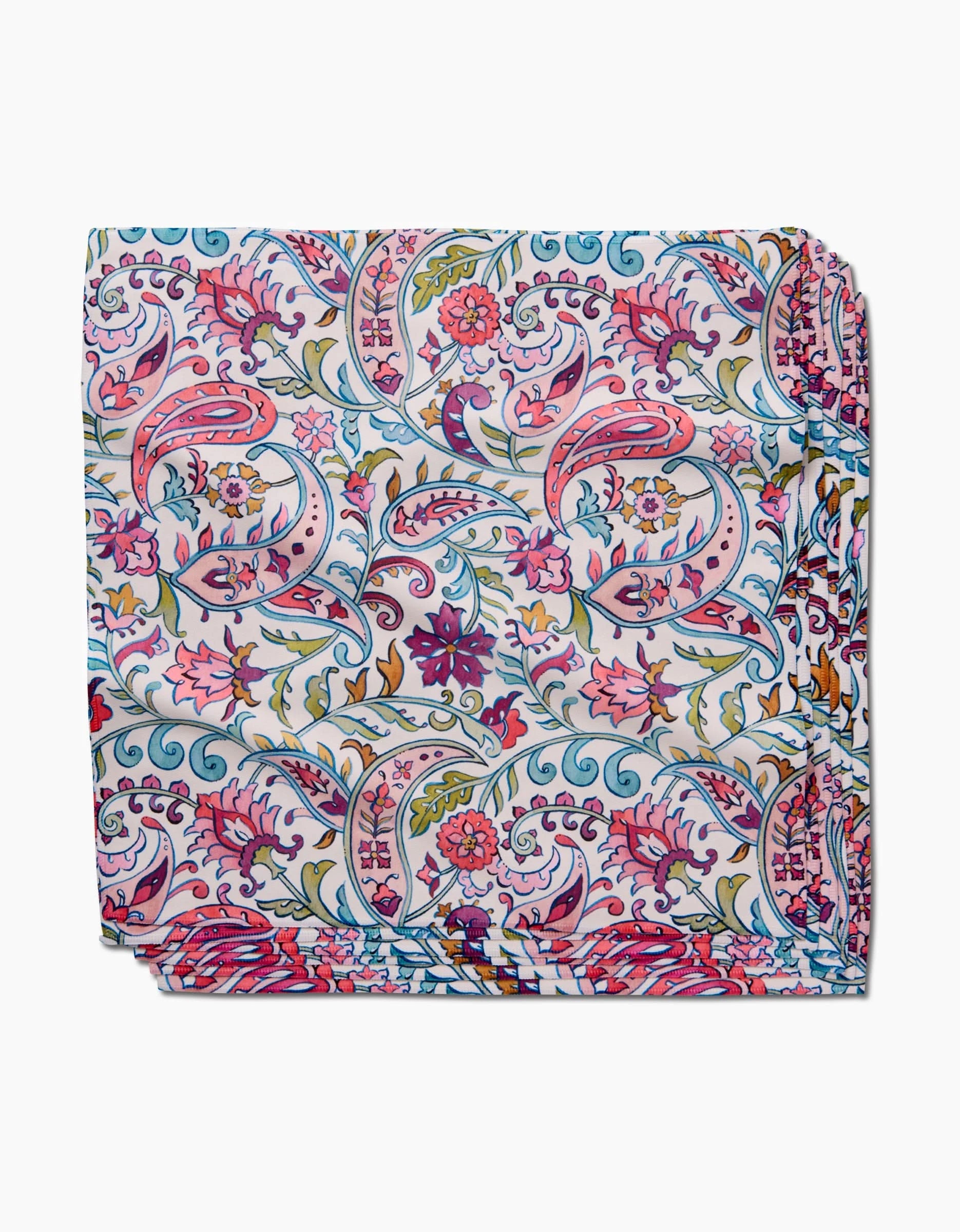 The Bazaar dinner napkin set by Maayan Alper-Swan features a vibrant floral and paisley pattern in pink, blue, green, yellow, and red on white, crafted from eco-friendly Geosuede fabric.
