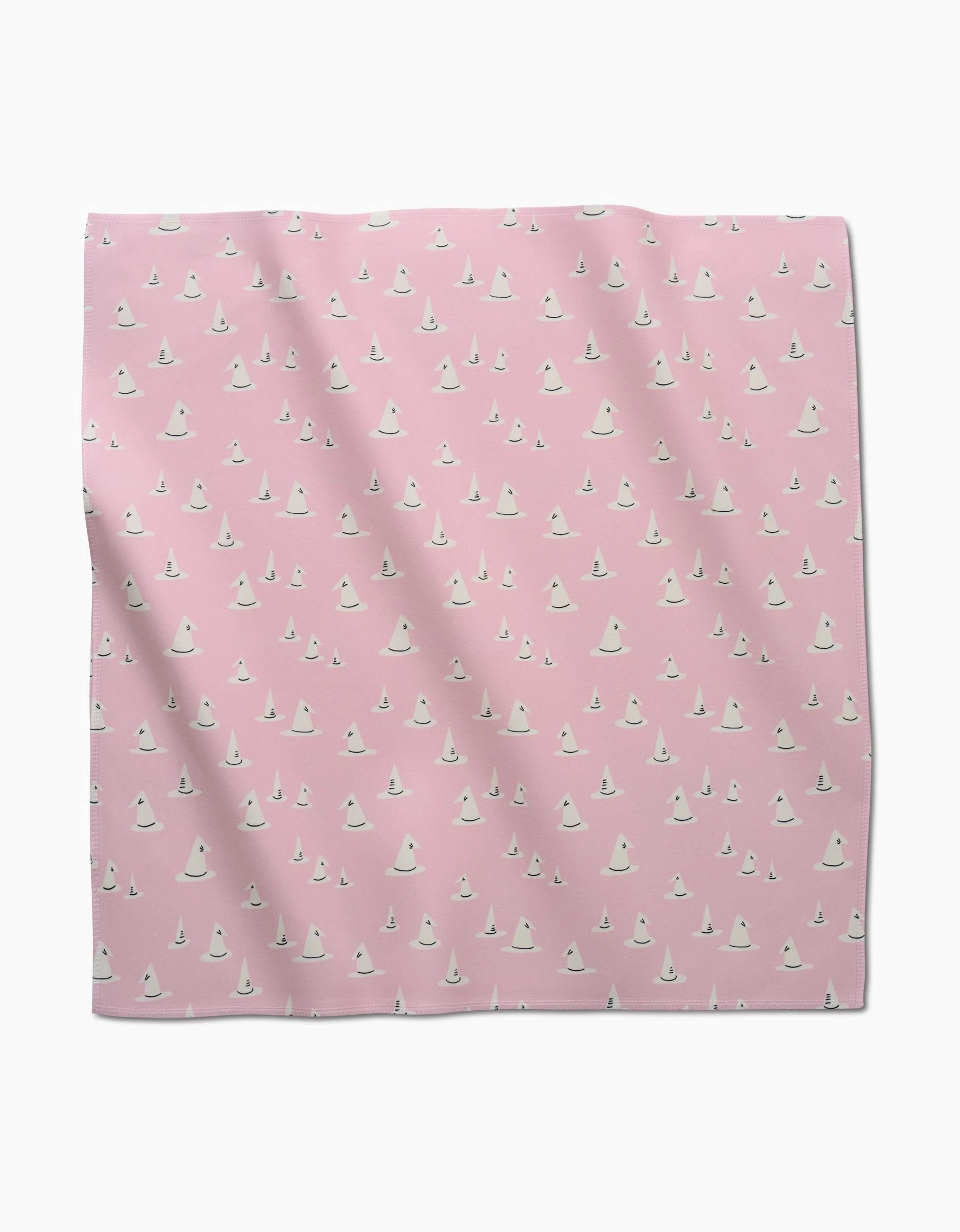 The Belladonna dinner napkin set by Amy MacCready features pink fabric squares with a repeating pattern of small white ghost-like shapes—an eco-friendly choice for gatherings.