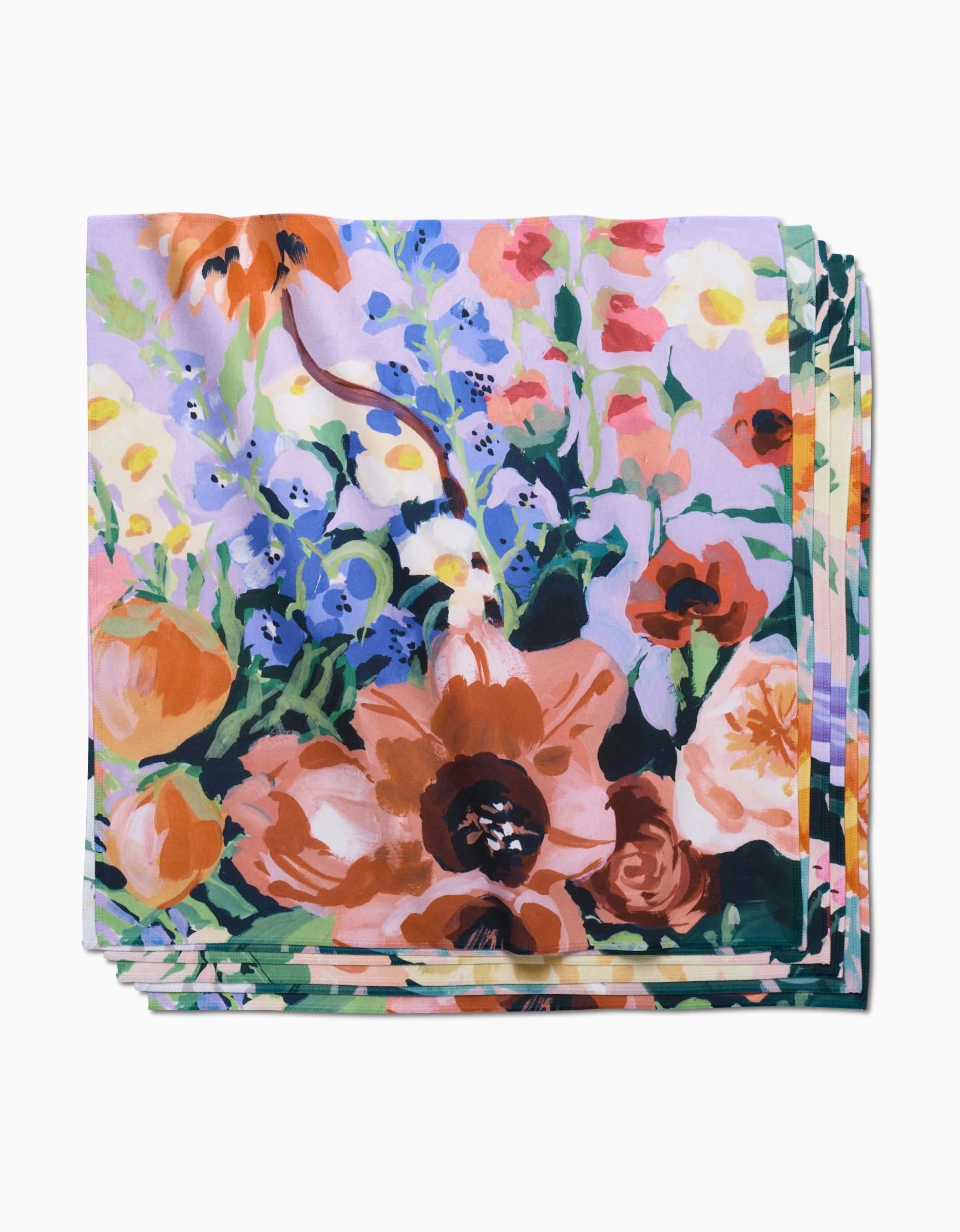 Bouquet by Ania Zwara Art: eco-friendly napkins with a bold, colorful floral print—orange, pink, purple, blue, and green flowers on light Geosuede fabric.