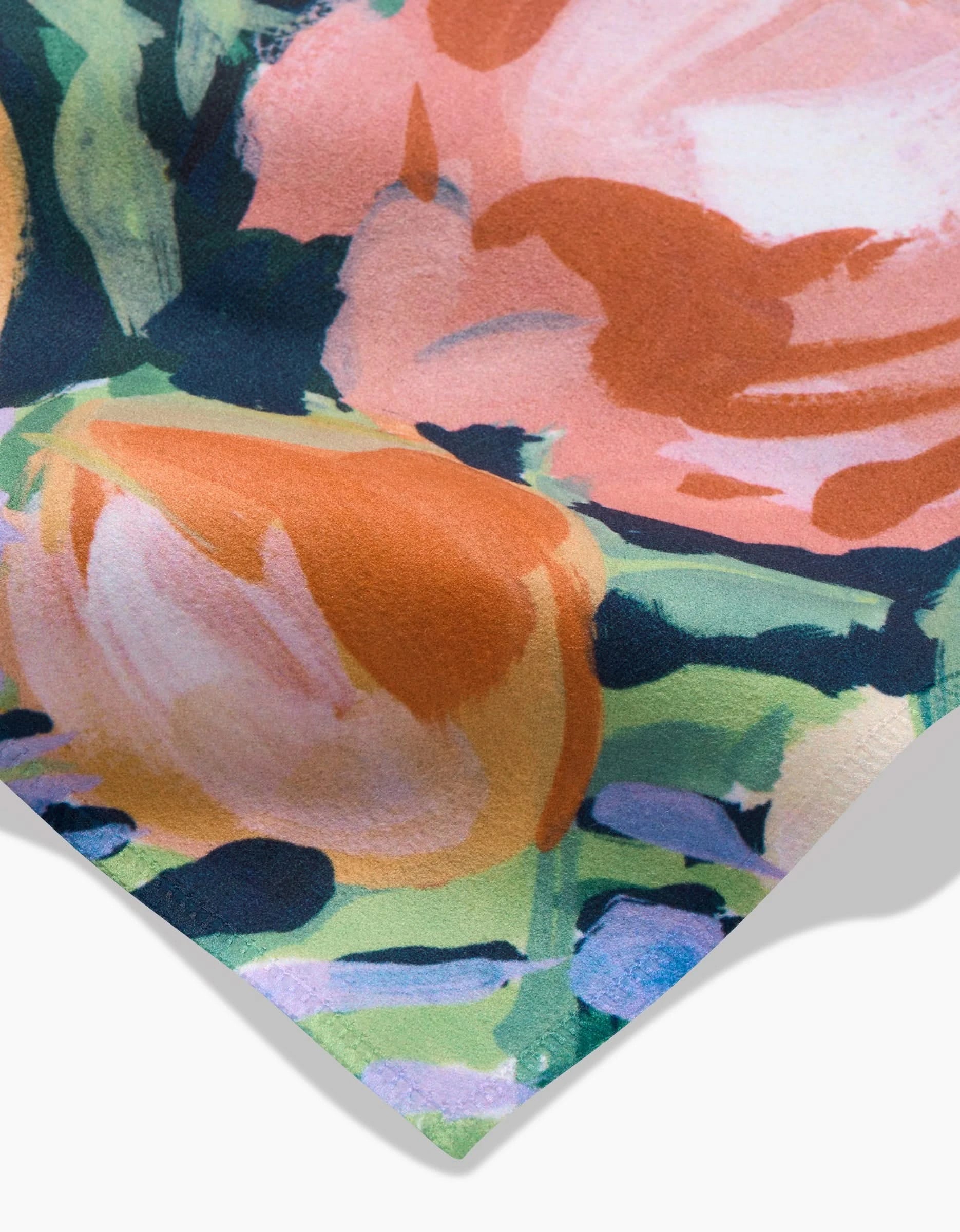 Close-up of Bouquet Geosuede fabric by Ania Zwara Art, featuring large pink and orange flowers with green and blue leaves on a dark background. Its texture is ideal for eco-friendly napkins or a dinner napkin set.