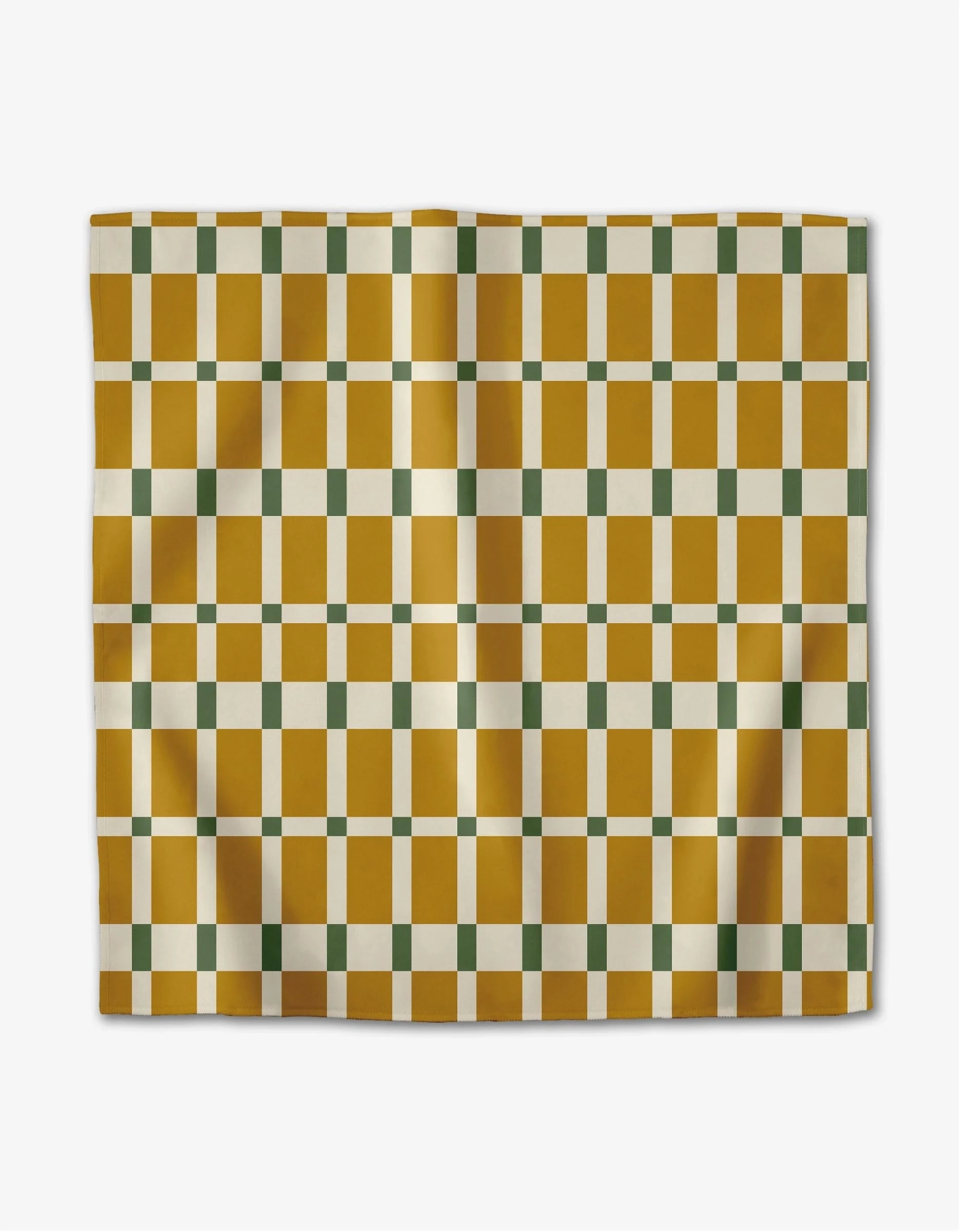 The Candy Plaid dinner napkin set by Rebecca Woolbright features a geometric pattern of mustard yellow and white rectangles with green squares, displayed flat on a light background.