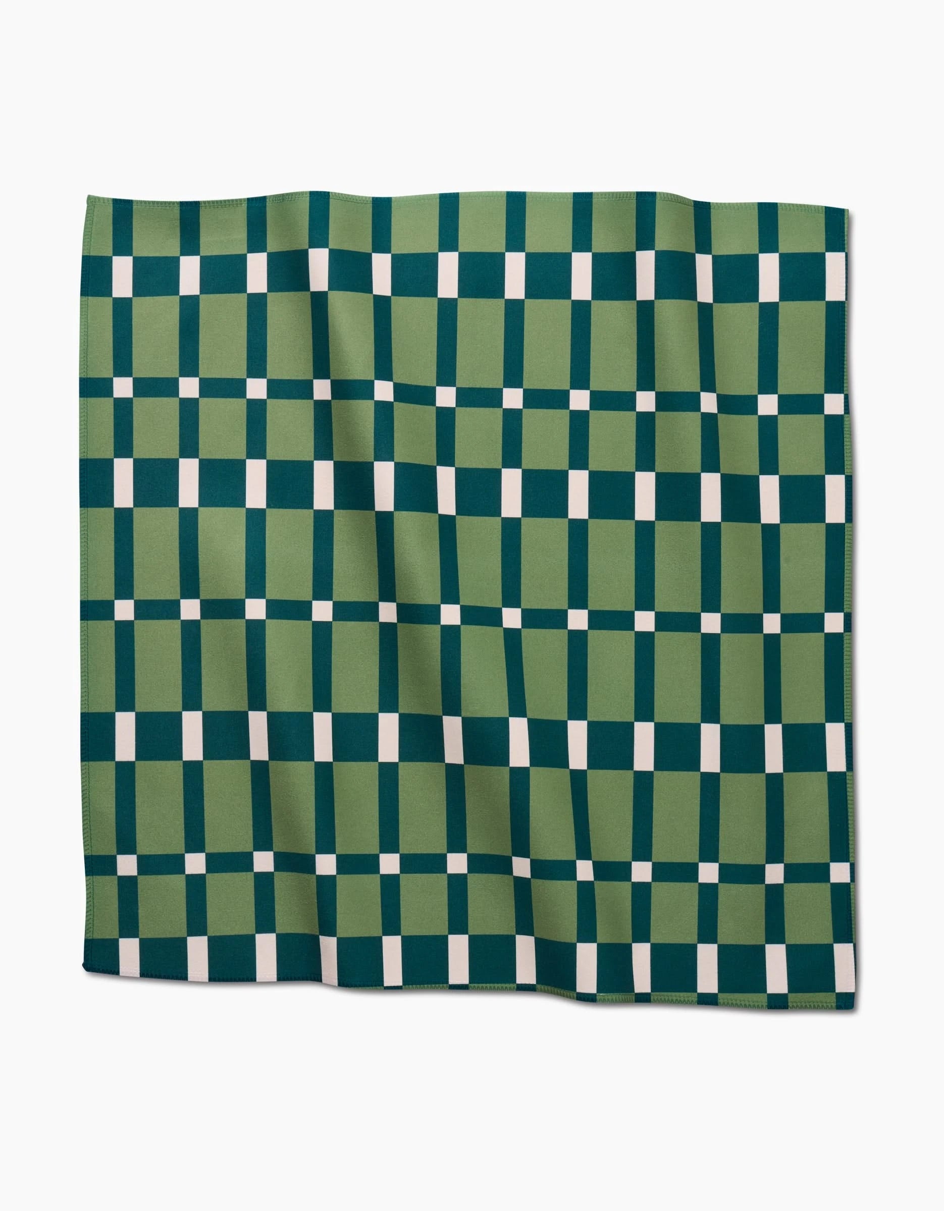 Candy Plaid dinner napkins by Rebecca Woolbright feature a green and dark teal checkered Geosuede fabric with white squares at each crosspoint. These recycled rectangular napkins have a slightly wrinkled appearance.
